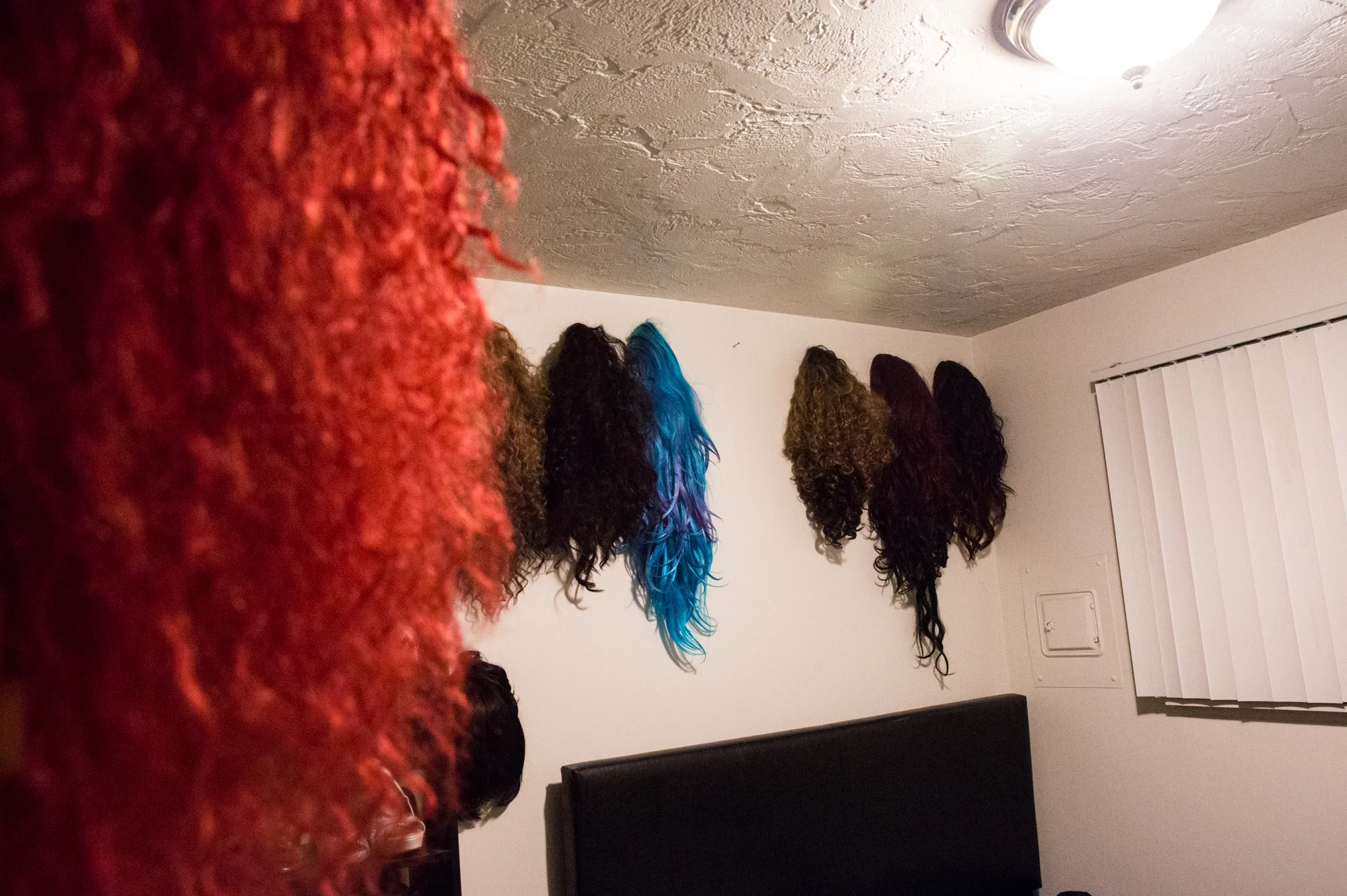  Nicky Serene's many wigs are displayed on the walls of Mark Harbaugh's drag room. Mark's choice of wig for the Glamazons show depends on the song choice, outfit and mood of the evening.&nbsp; 