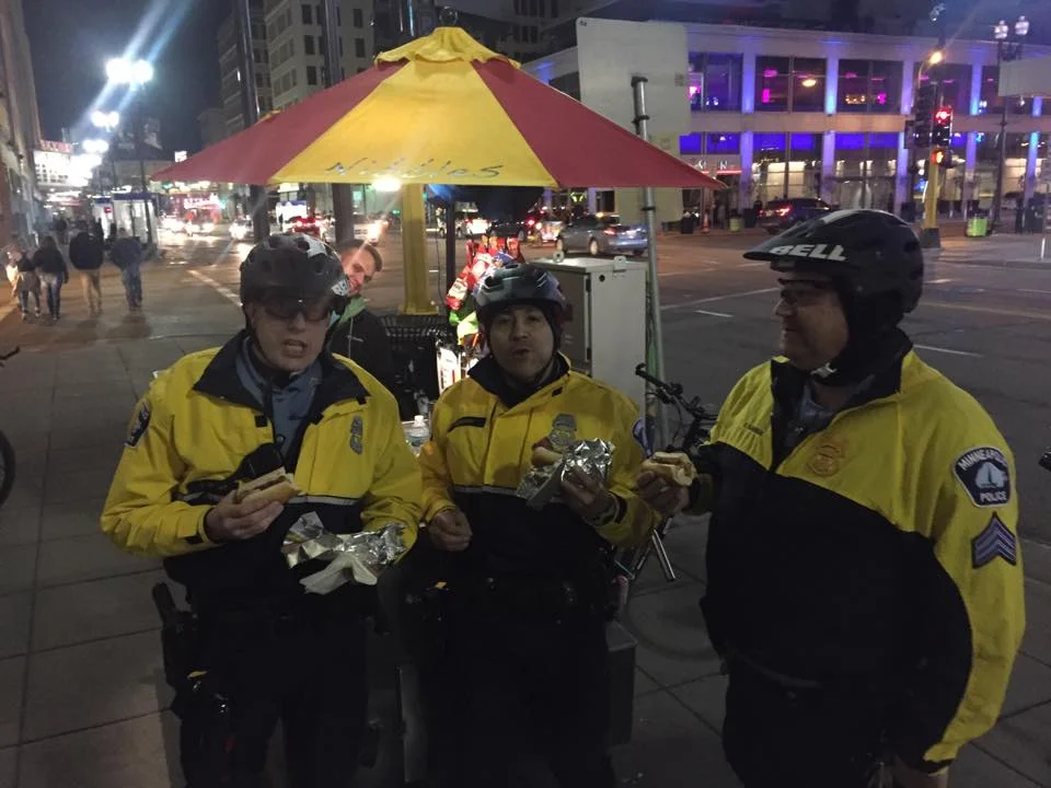 Police officers enjoying Nibbles hot dogs