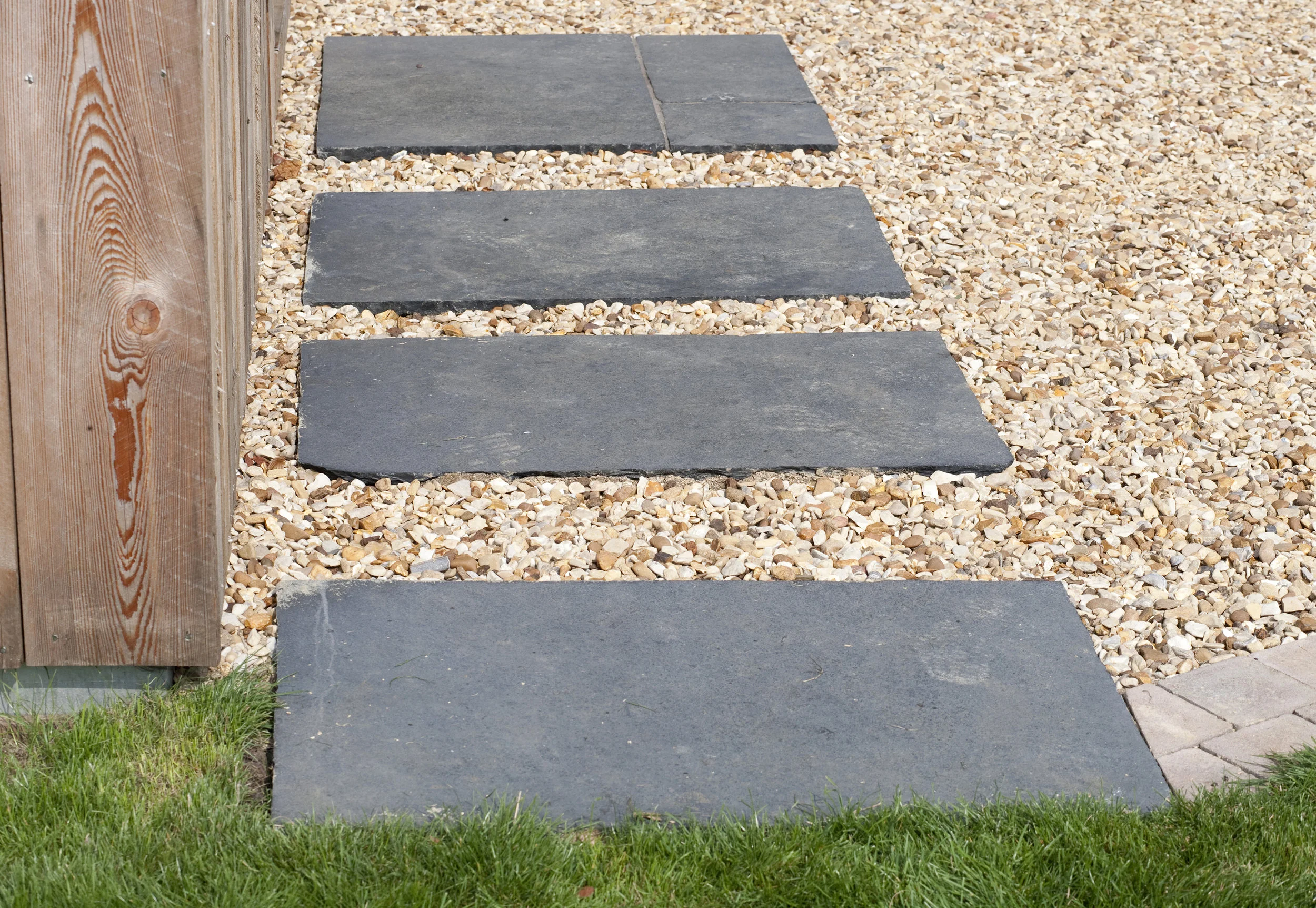 Stepping stones made of Indian slate are a stunning way to create contrasting colour and texture for Nicola's garden walkway.