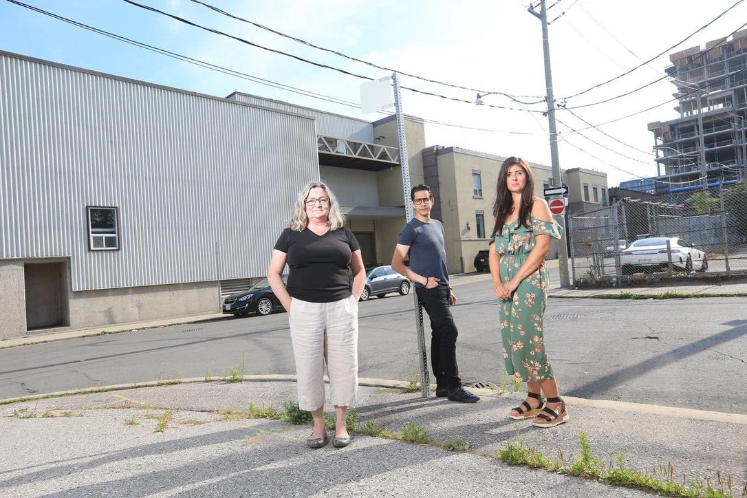 Three artists standing in front of Akin River art studio at 7 Labatt Ave in Toronto.