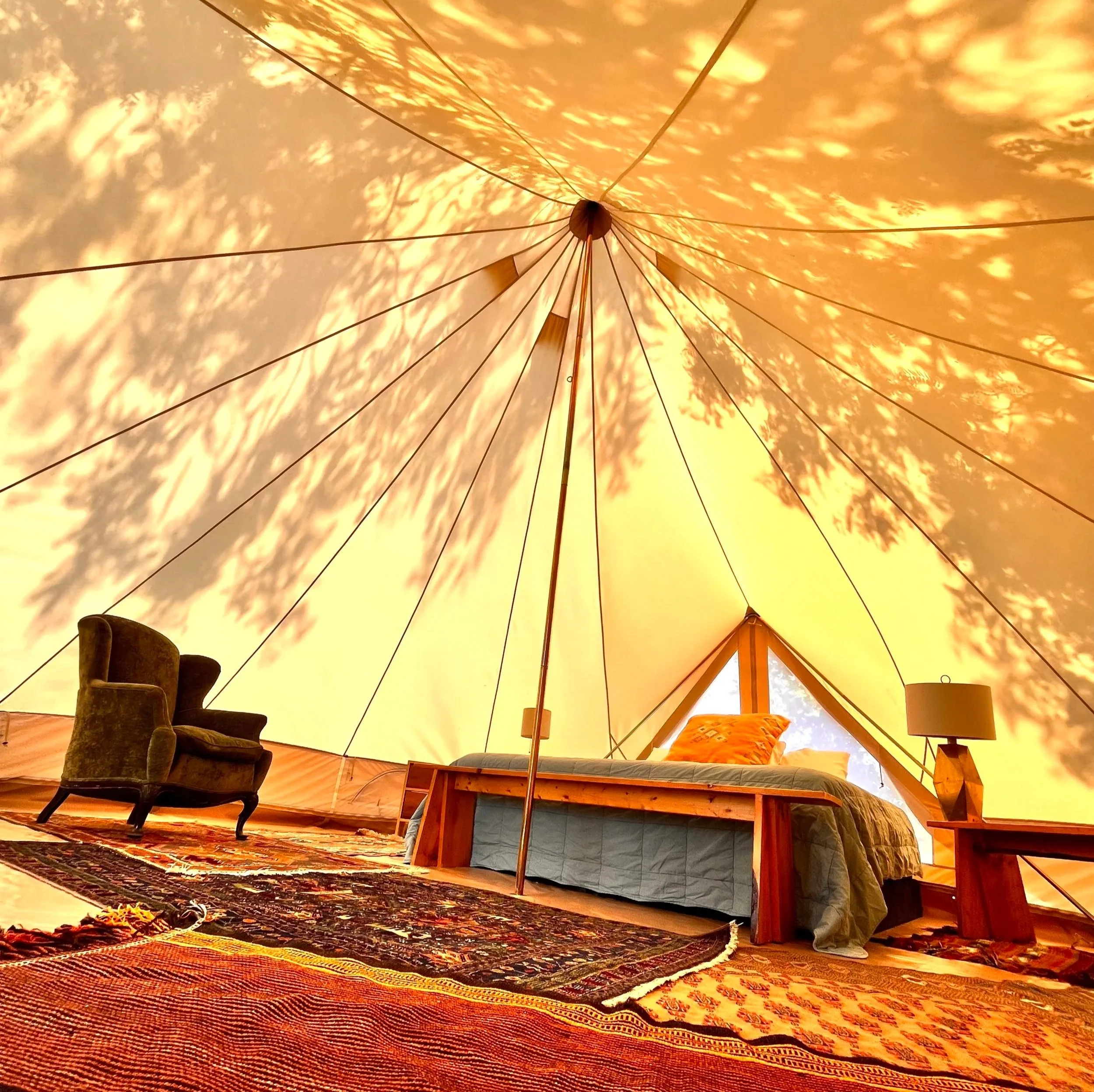Salmon River Akin art studios image of  inside large tent with bed and chair