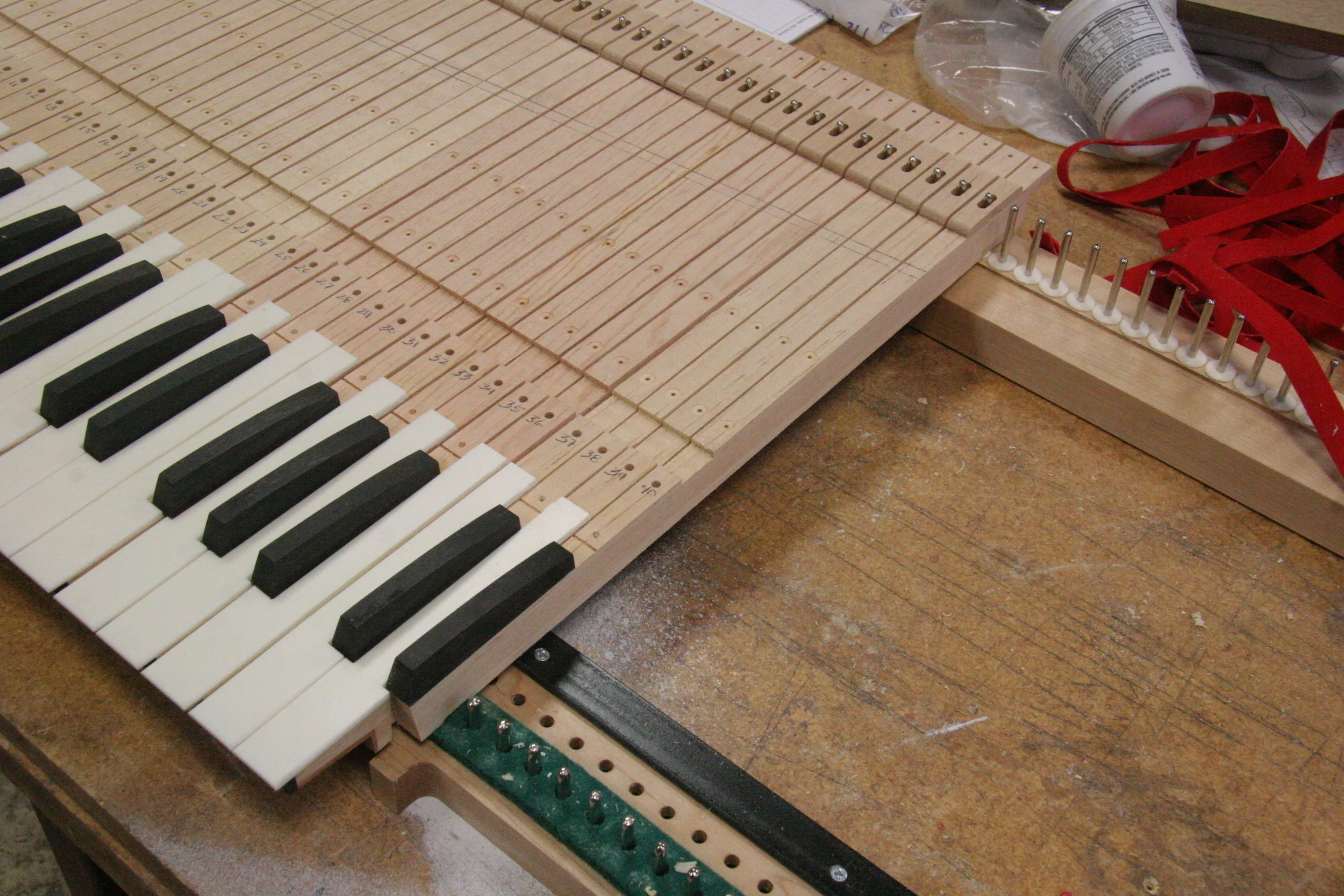 We started machining our keyboards on a CNC router about 2003. CNC machining lends itself great for the job as you can machine every octave to exact precision, Unlike layout by hand, where there is always some variance from octave to octave, these manuals are exact and perfect octave to octave. We have employed two strategies for machining, If the keyboard blank is thin from .375 to .5 inches we use a vector cut and long .125 cutter can to cut the full key body. It requires "spacing" the layout to allow for the extra width of the cutter but it limits the amount of hand work greatly, The other strategy is to do a vector cut using a .0625 cutter hand ground to .040 inches as a layout aid only, then every operation is typical of the traditional means using band saws and hand tools. Of course the key beds and blanks are all drilled using the CNC thus cutting down errors and time.