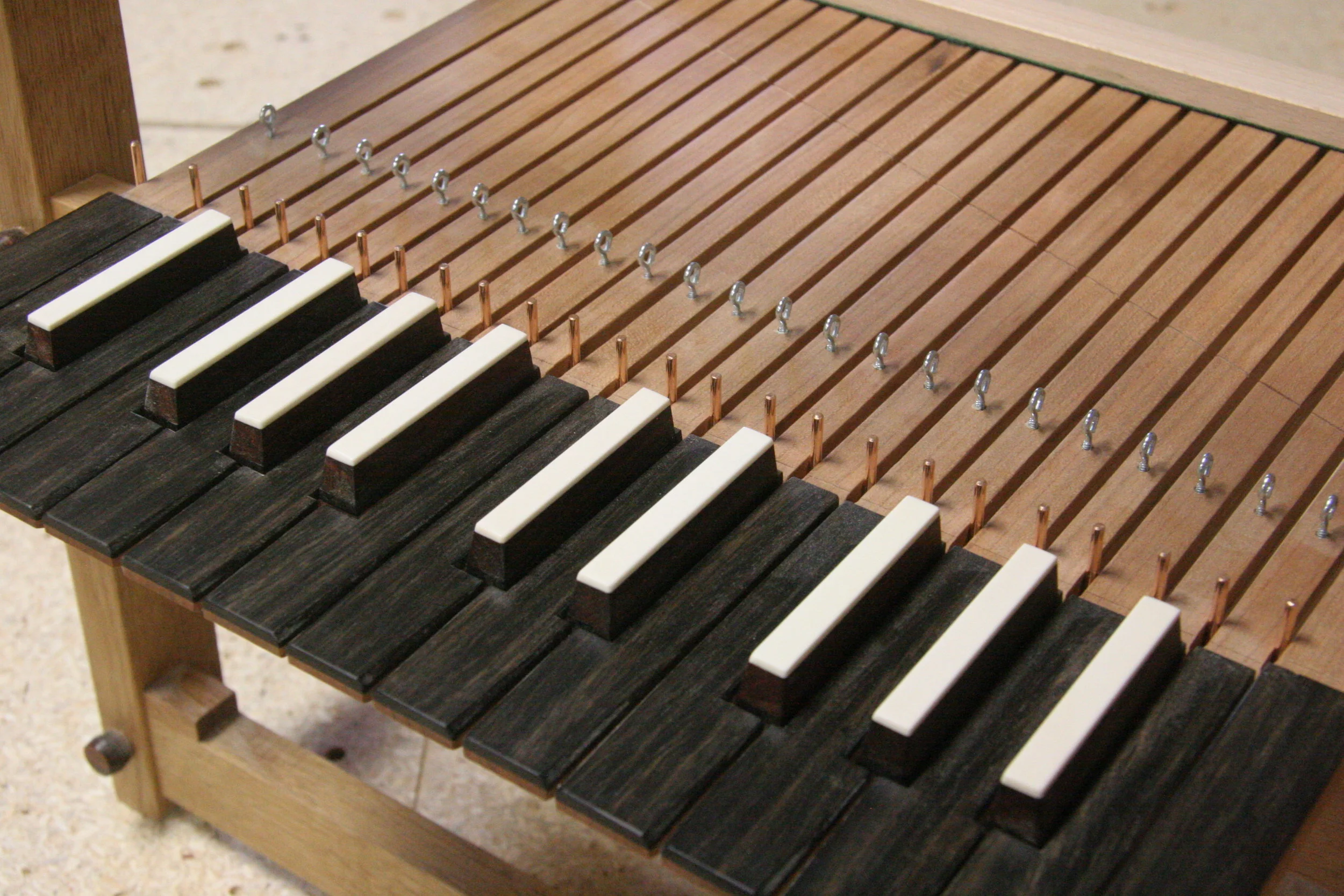 Ebony naturals with bone and cocobolo sharps,quartersawn cherry key blank. This keyboard is cut on the CNC router using .125 and .25 end mills, the geometry is drawn to allow for the kerf of the cutter. This makes for very little hand work.