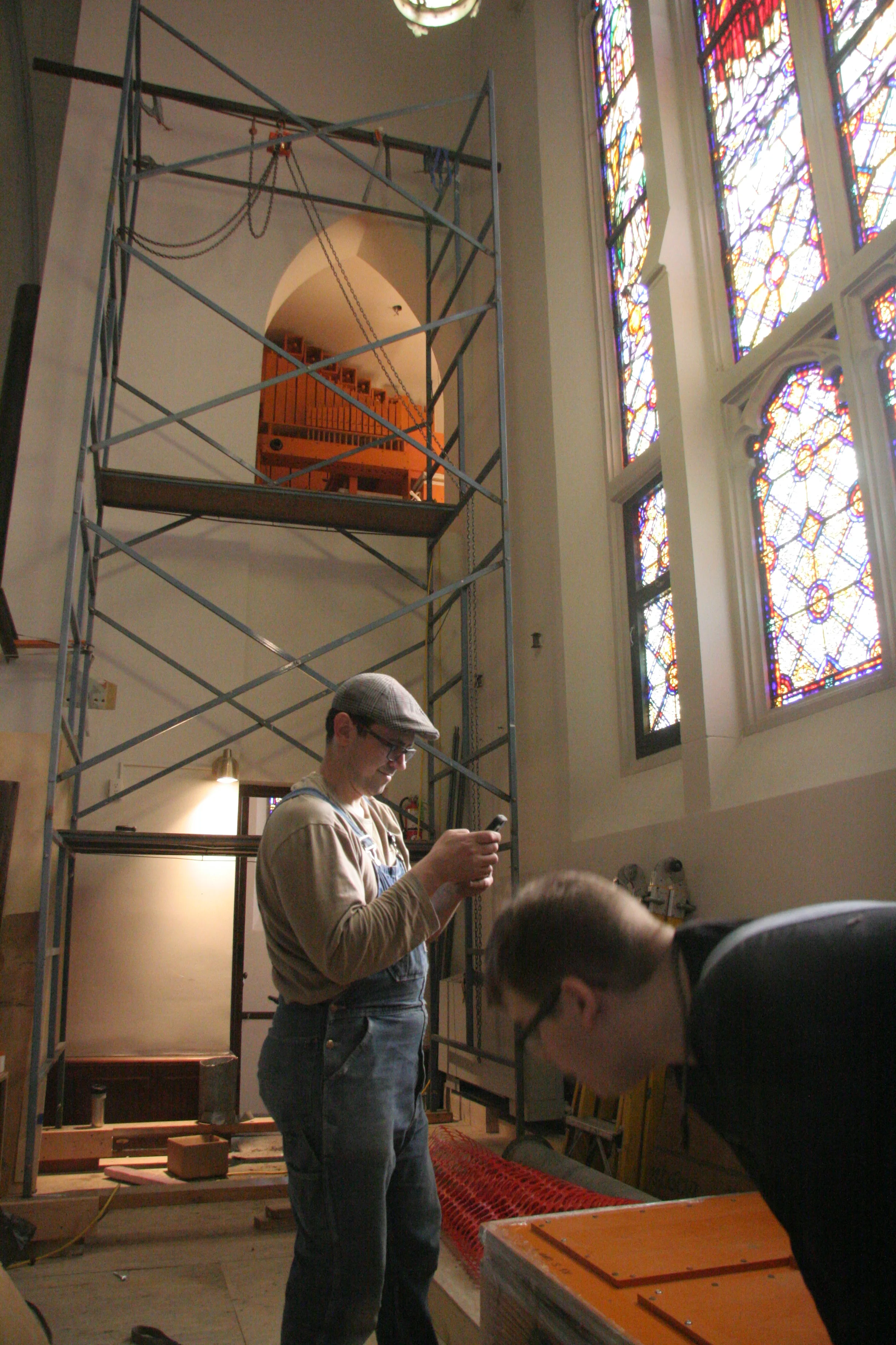 Donald Nordlie and Joe Brown with background showing pedal chamber and scaffolding.