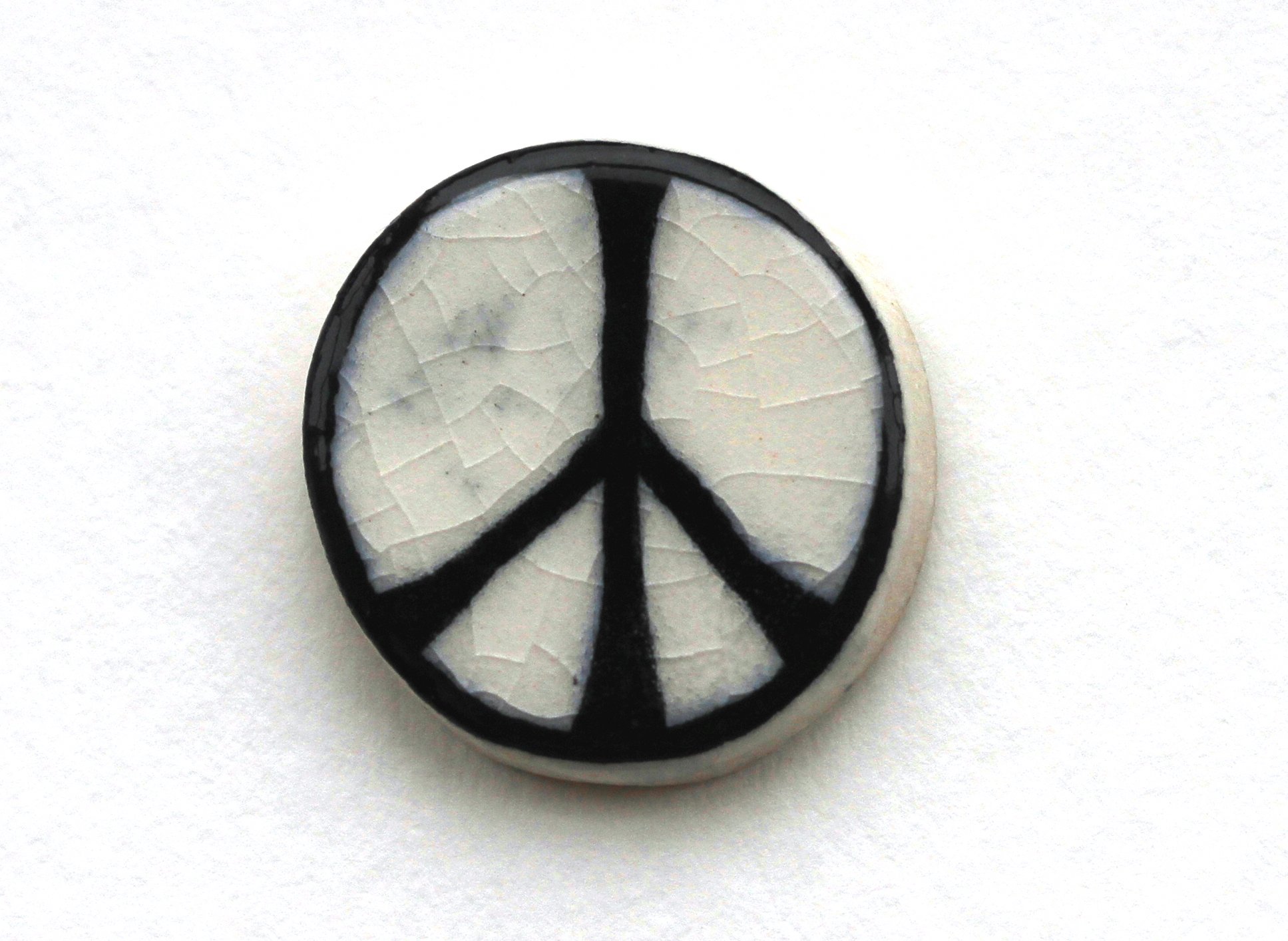 An original CND ceramic badge via http://www.cnduk.org/about/item/435-the-cnd-symbol