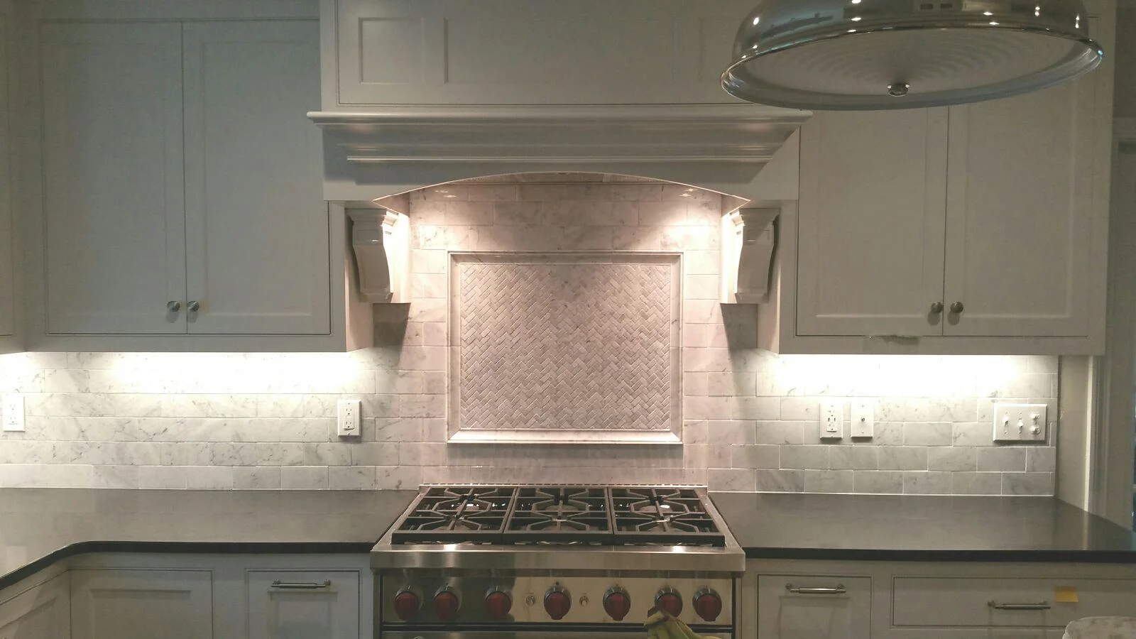 Marble backsplash with picture frame in Sherborn