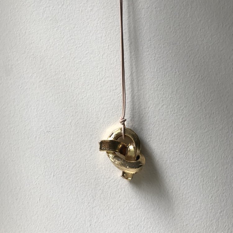 MINI UNION KNOT | GOLD ceramic knot on leather cord approx. 2”L, 1.5”H, 1”W (varies) $33 Wholesale | $65 Retail
