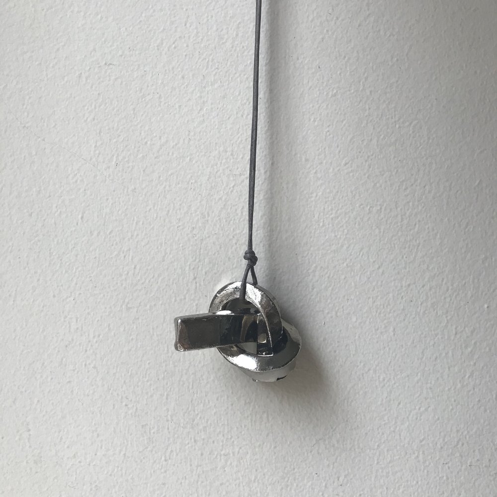 MINI UNION KNOT | SILVER ceramic knot on leather cord approx. 2”L, 1.5”H, 1”W (varies) $33 Wholesale | $65 Retail
