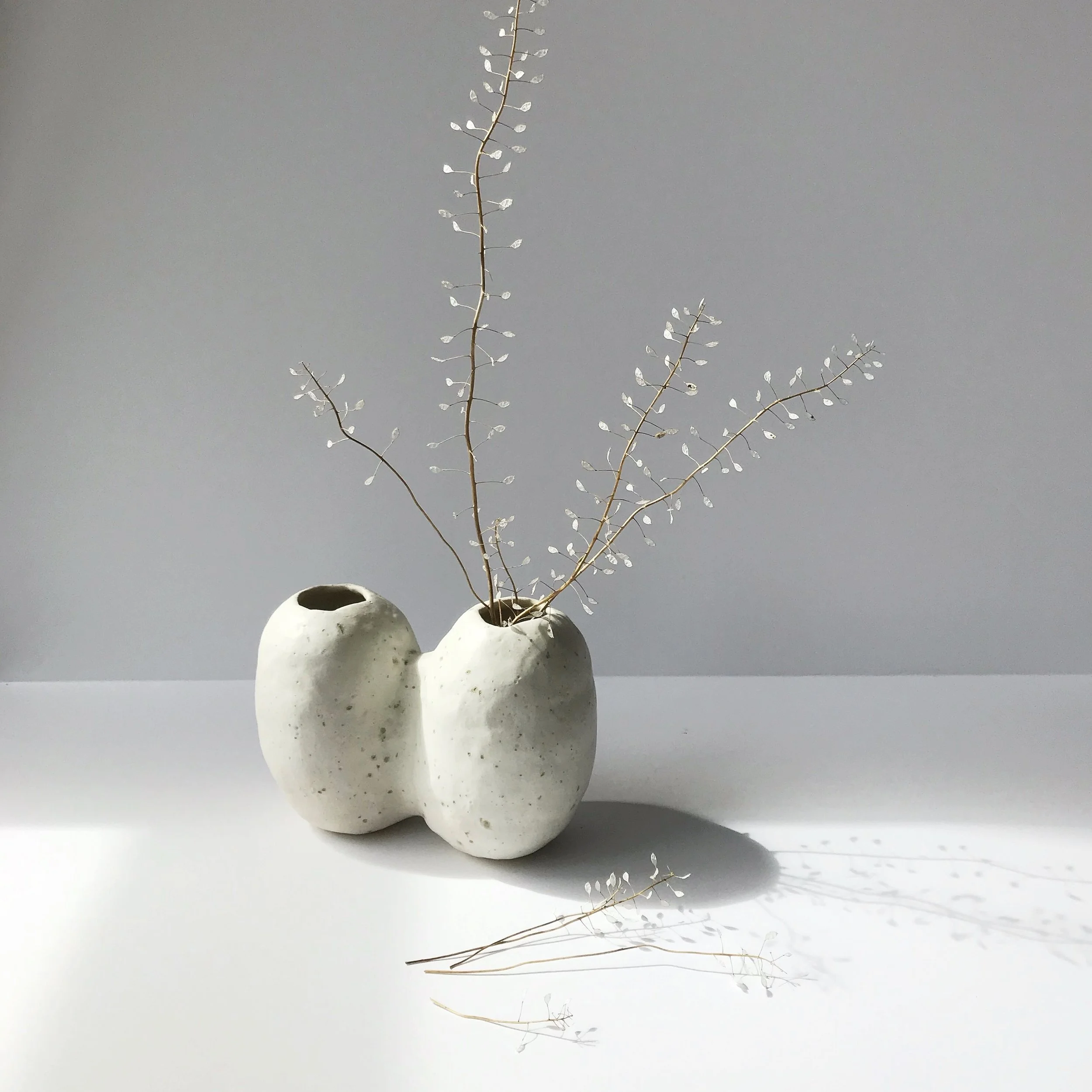 TWIN NIWAKI VASE hand build stoneware bud vase measures approx. approx. 6.5” across x 3” wide x 5" tall $60 Wholesale | $120 Retail