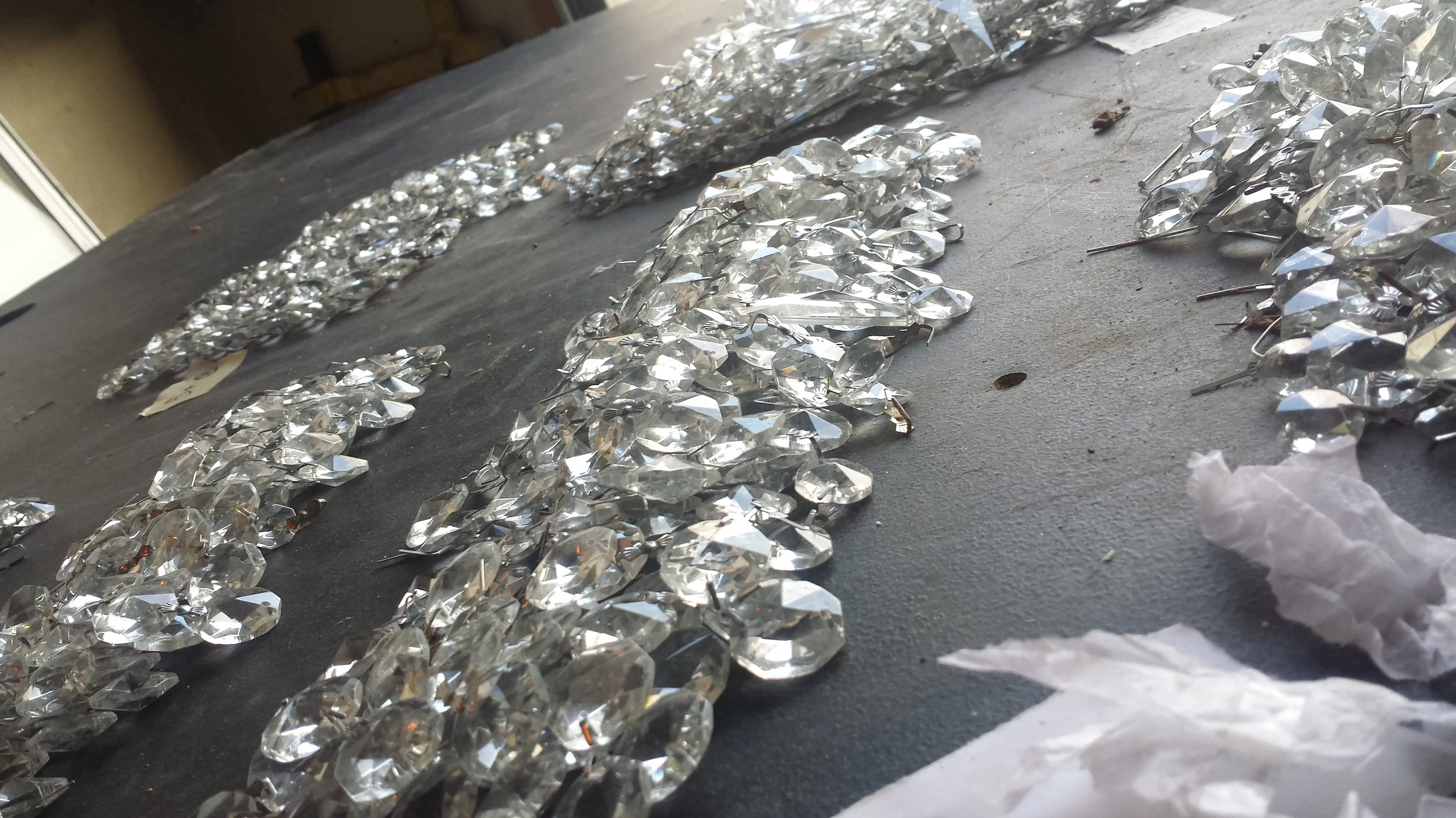 Hundreds of chandelier crystals separated and ready to string. 