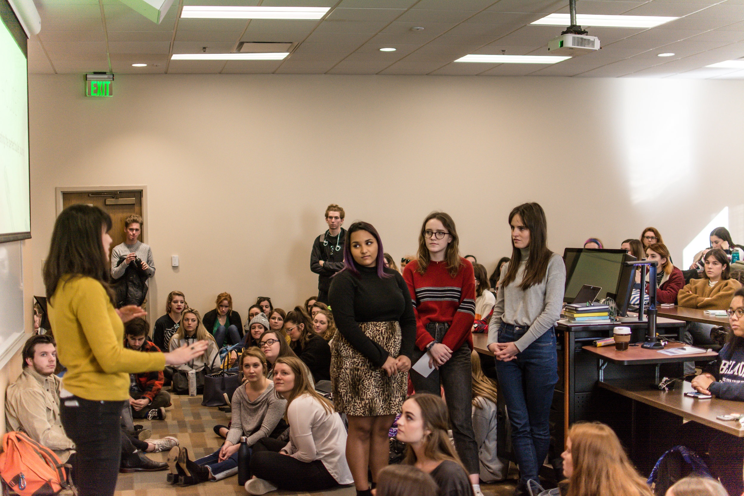 Delilah, Emily, Hannah, and the crowd listen to Elizabeth’s introduction.