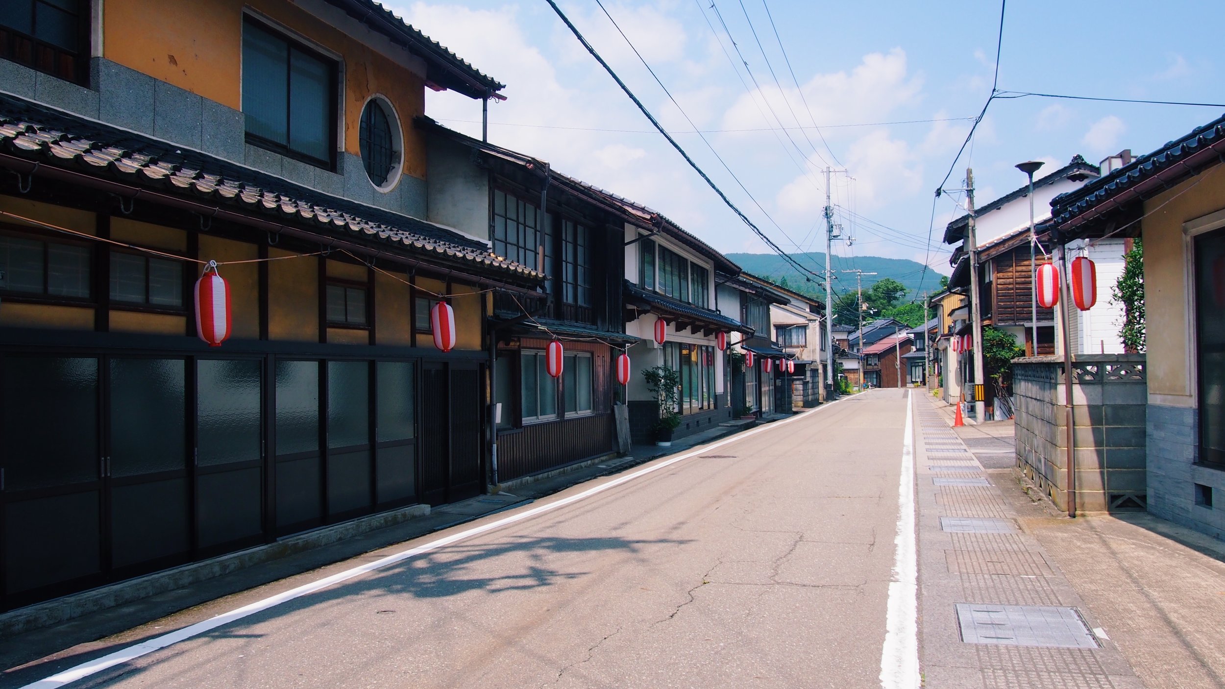 Japanese rural village street lined with summer festival lanters