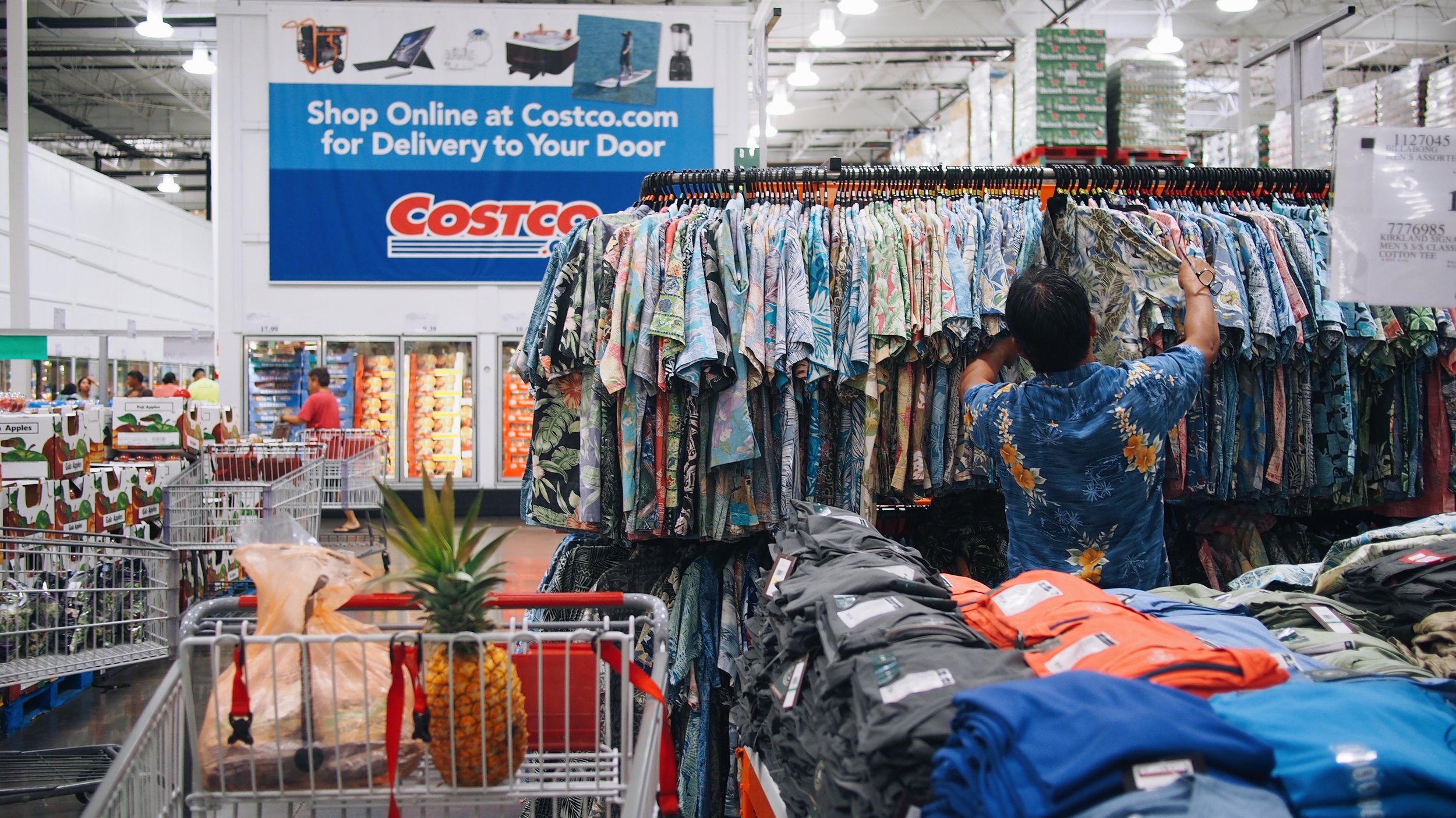 man looking at aloha shirts at hawaii costco
