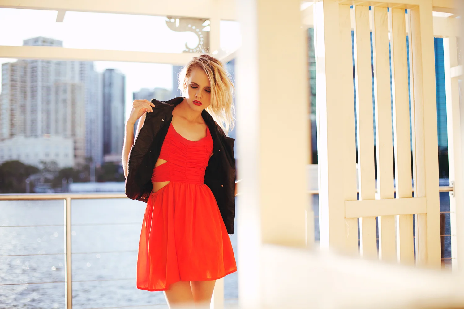 Brisbane, QLD Australia Fashion Photographer Stacey Russell || Fashion Photography Model Photoshoot || girl wearing red dress and leather jacket posing under gazebo near river