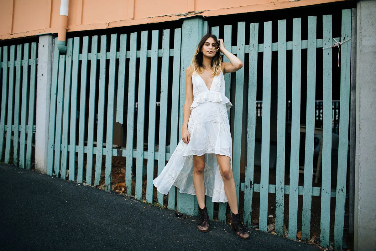 Brisbane Model Photographer Stacey Russell || Professional Australia Fashion Photography Modelling Photoshoot || Model portfolio image of girl in white dress beside pastel green fencing (Copy)