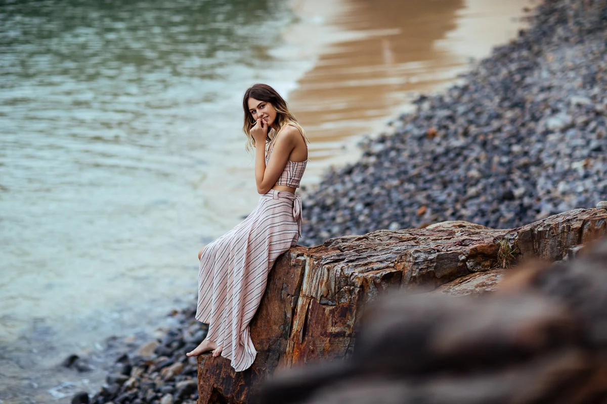 Brisbane Model Photographer Stacey Russell || Professional Australia Fashion Photography Modelling Photoshoot || Model portfolio image of girl sitting on beach cliffside in pink dress (Copy)