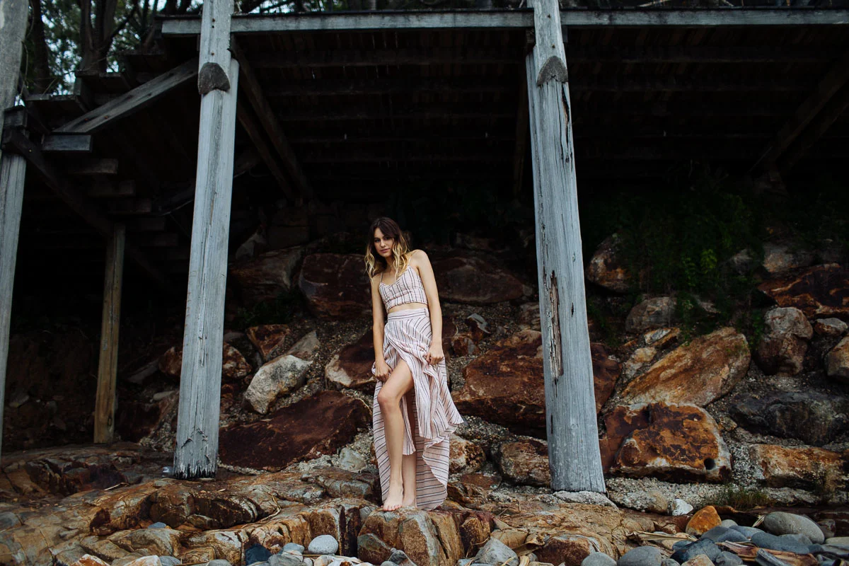 Brisbane Model Photographer Stacey Russell || Professional Australia Fashion Photography Modelling Photoshoot || Model portfolio image of girl in pink dress standing on rocks near posts (Copy)