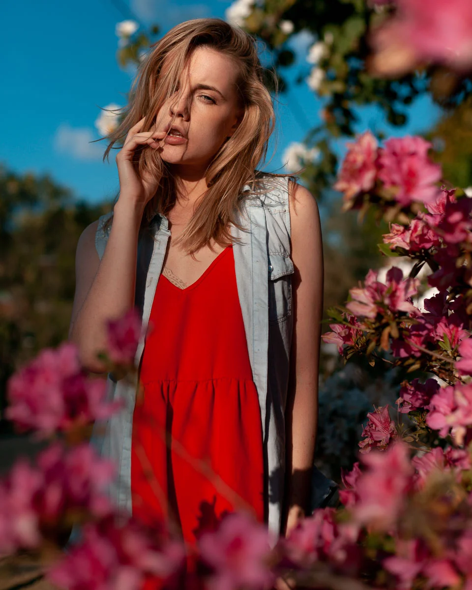 Brisbane Australia Fashion Photographer Stacey Russell || Fashion Photography Modelling Photoshoot || Model portfolio image of blonde girl modelling red dress and denim jacket between pink flow (Copy)