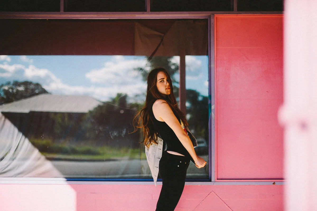 Brisbane Model Photographer Stacey Russell || Professional Australia Fashion Photography Modelling Photoshoot || Model portfolio image of girl standing infront of pink shopfront window