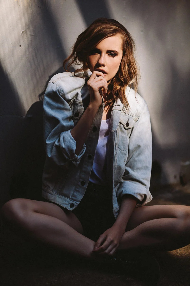 Brisbane Model Photographer Stacey Russell || Professional Australia Fashion Photography Modelling Photoshoot || Model portfolio image of girl sitting in shadows wearing light denim jacket (Copy)