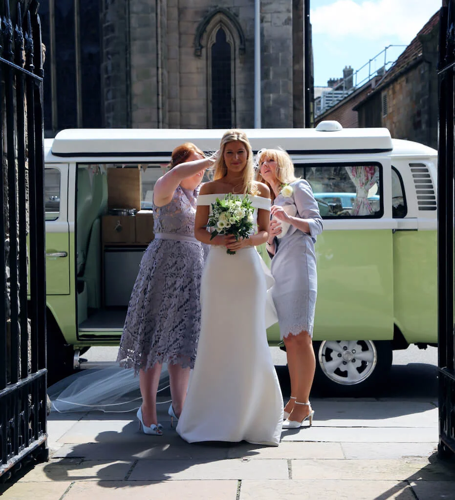Bride arriving at St Andrews university in Moomin our VW camper wedding car