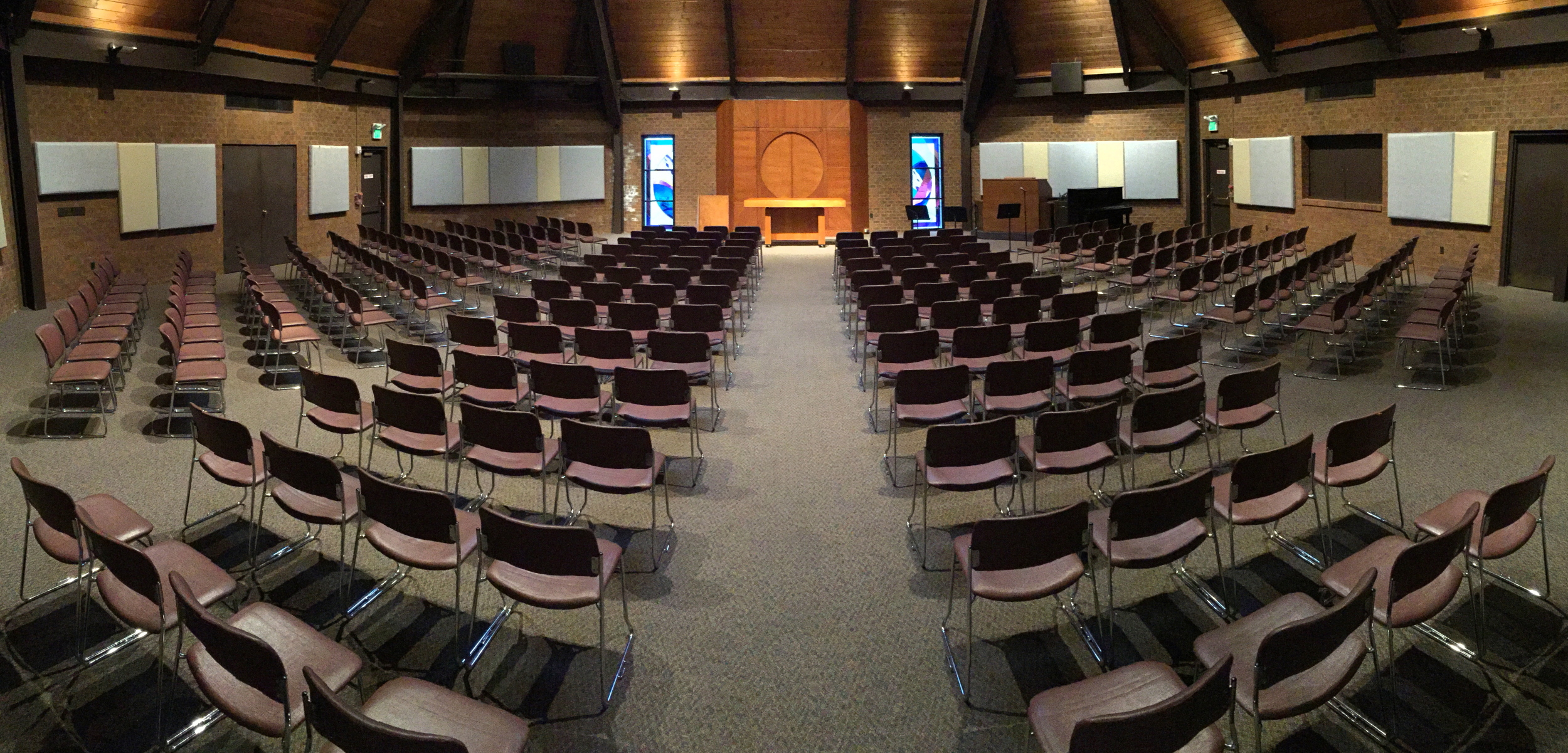 Room 100 set up in worship style with organ and piano