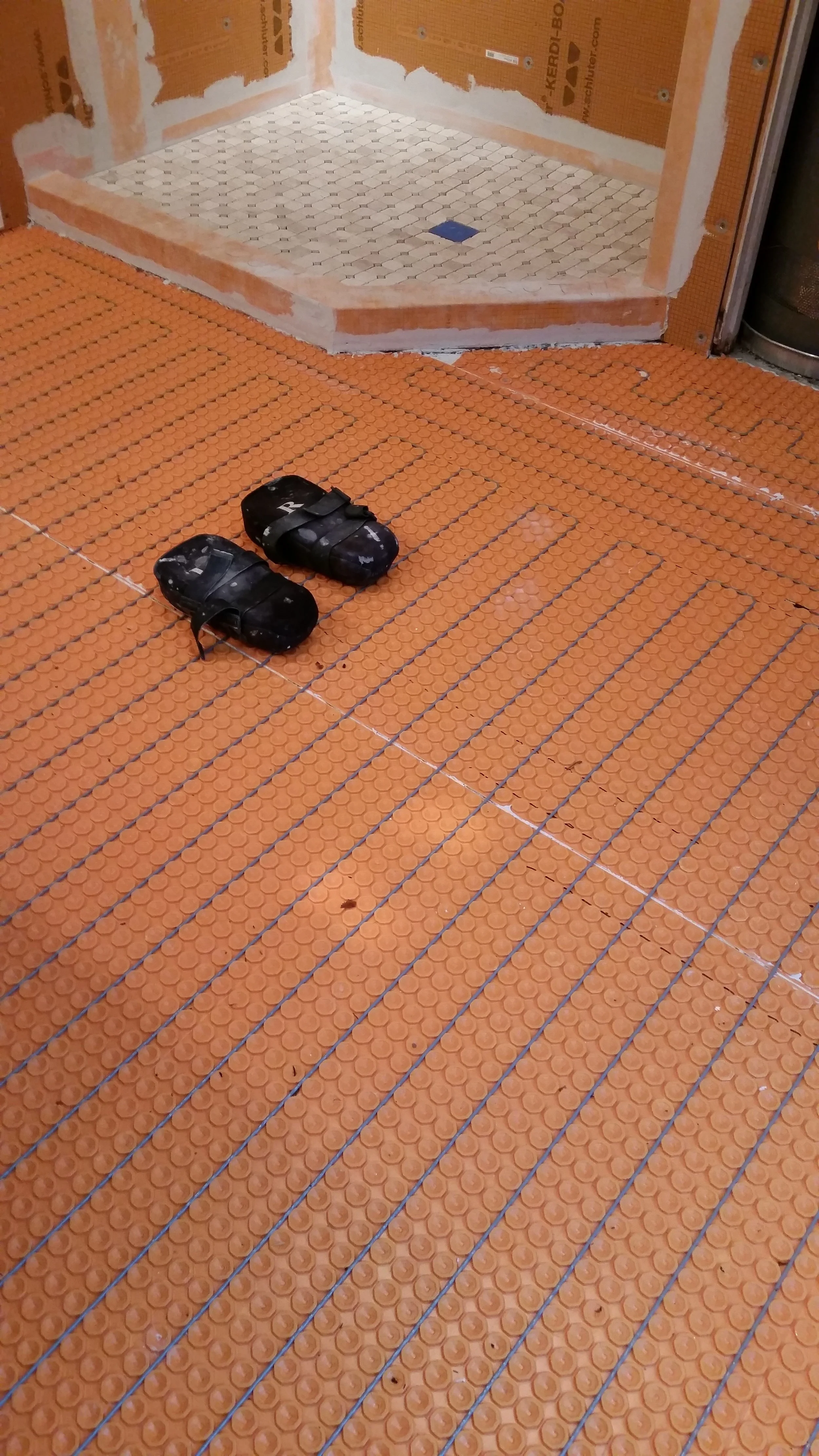 Another heated floor system. Ditra heat with a properly prepped shower in the background. If you care about how your shower is put together or the steps involved in completing your project...You're the customer for us!