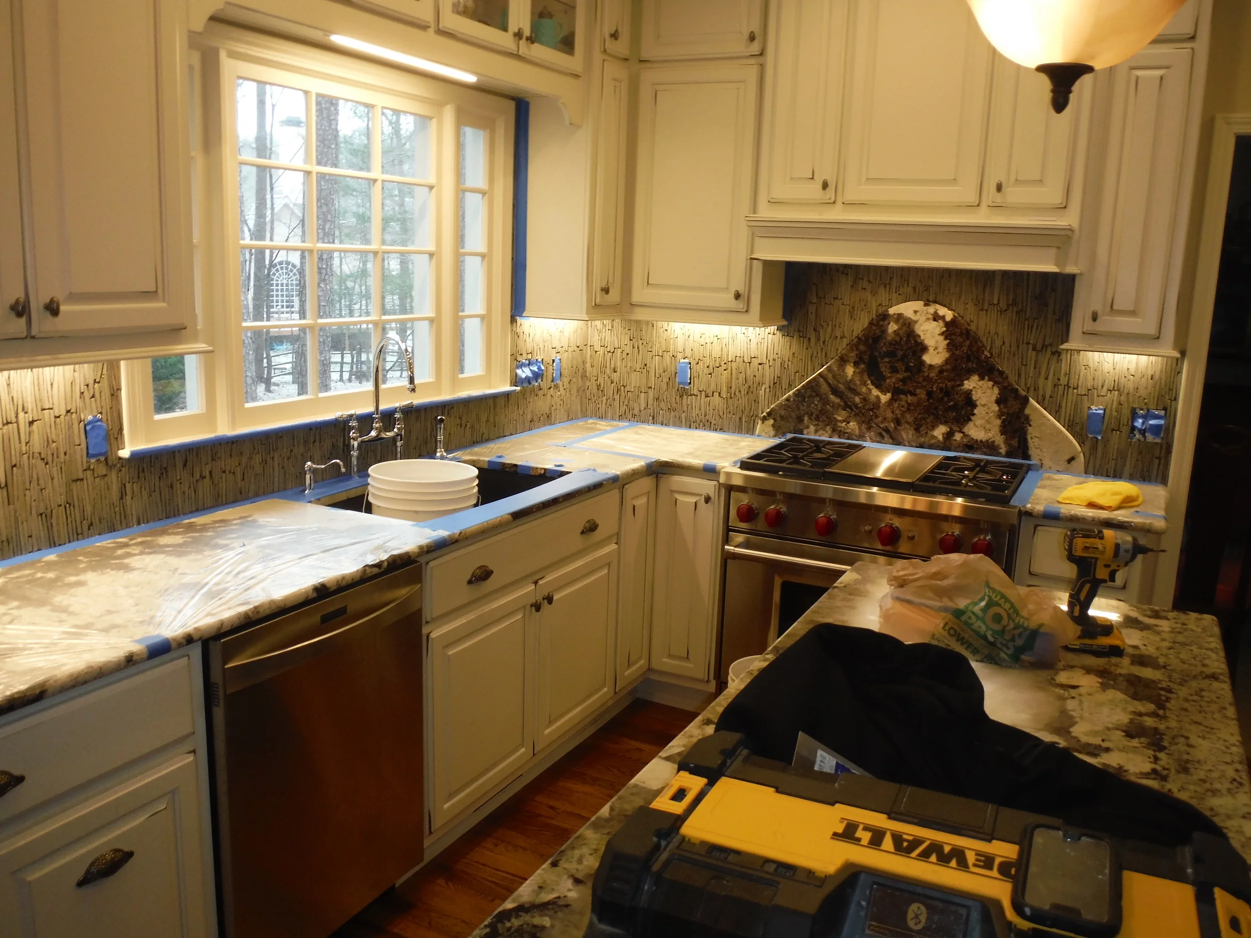  A custom backsplash install. We recessed that 100lb pound of granite into the wall behind the stove. The homeowner called it her "mountain" 