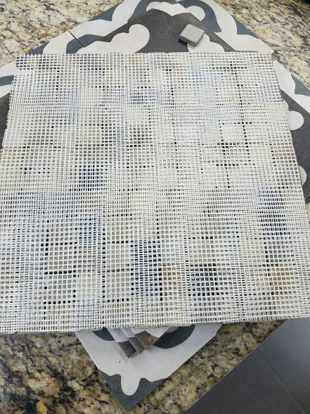 Do you think any of the thin set gets through this double mesh to touch any of the tile? Do you think any of the thin set gets through the double mesh to lock the tile in place? The answer is no. We send this material back.