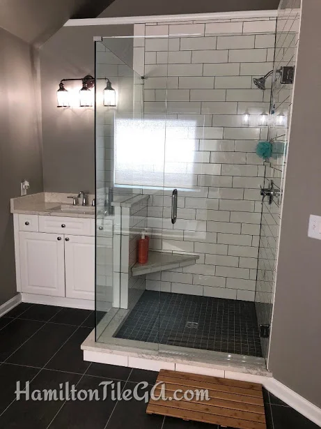 Notice, no clips on top of the curb holding the glass panels. They are simply NOT NECESSARY and the only thing they do is provide water a place to potentially escape. Pay attention to this. Also, ALL 100% Silicone sealant in the corners and plane changes. THIS is what separates the pros from the amateurs. We don’t grout our corners or use cheap latex caulking. It’s national standards, SO THAT’S WHAT WE DO!