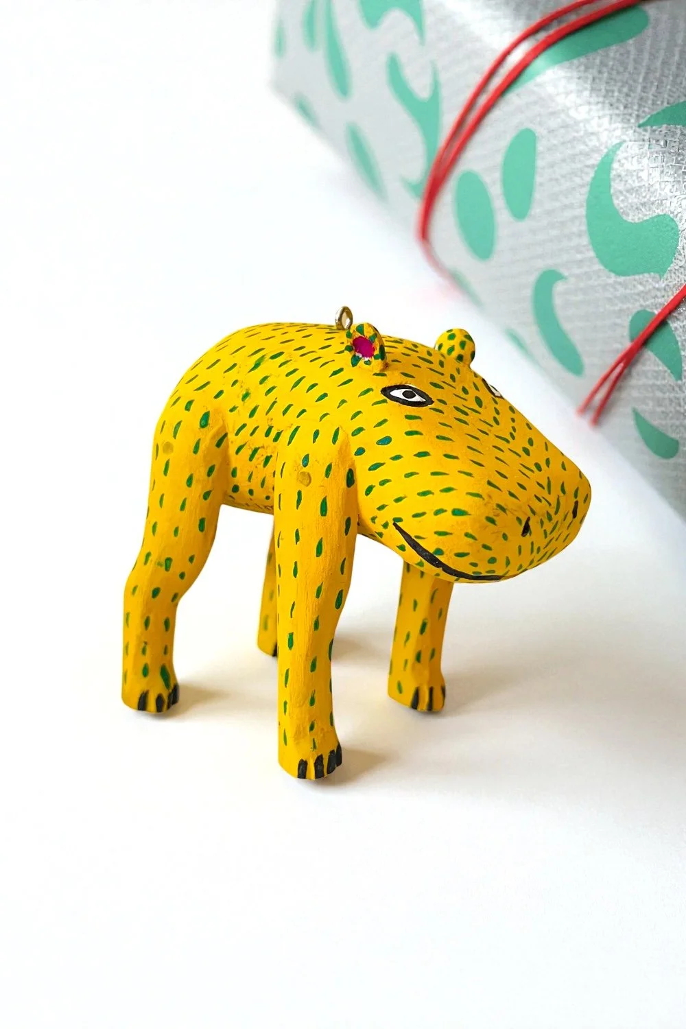 Carved yellow hippo ornament