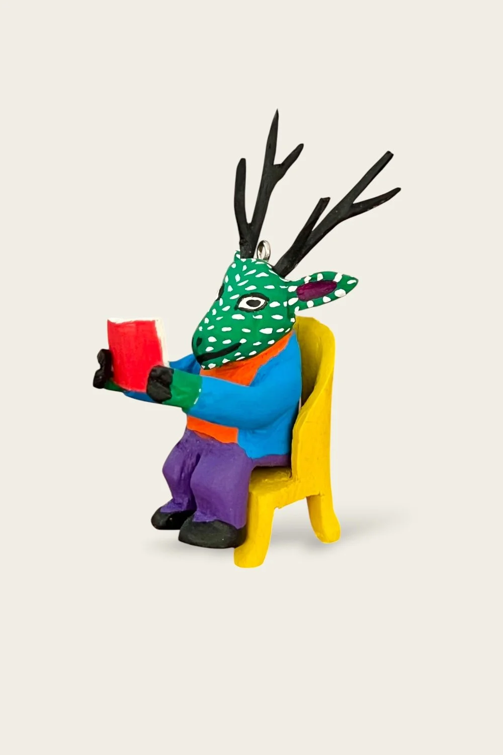 Carved Oaxacan ornament of a stag reading