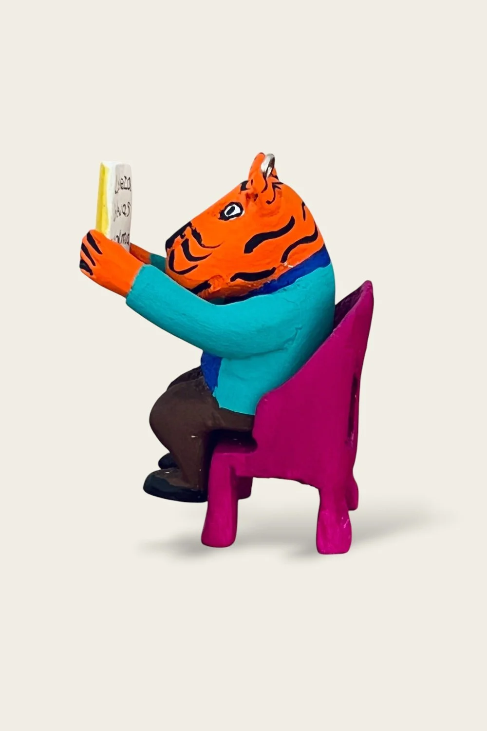 Oaxacan carved ornament of a tiger reading