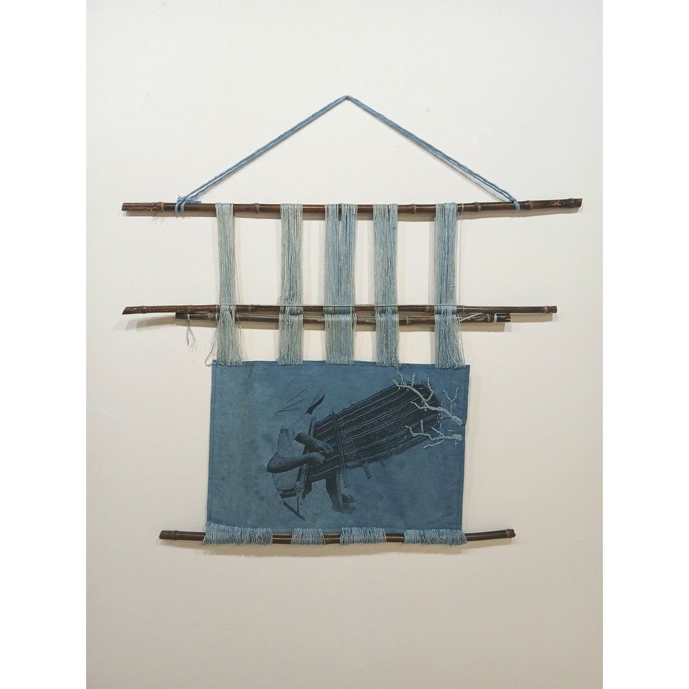 Marcela Sinnett, &quot;Synthetic Memory,&quot; 2025. Silkscreen on indigo-dyed muslin and yarn, bamboo sticks, 31 x 33 inches. ⁠
⁠
&ldquo;This piece reflects how the indigenous practice of weaving on a backstrap loom is quickly disappearing in El Sal