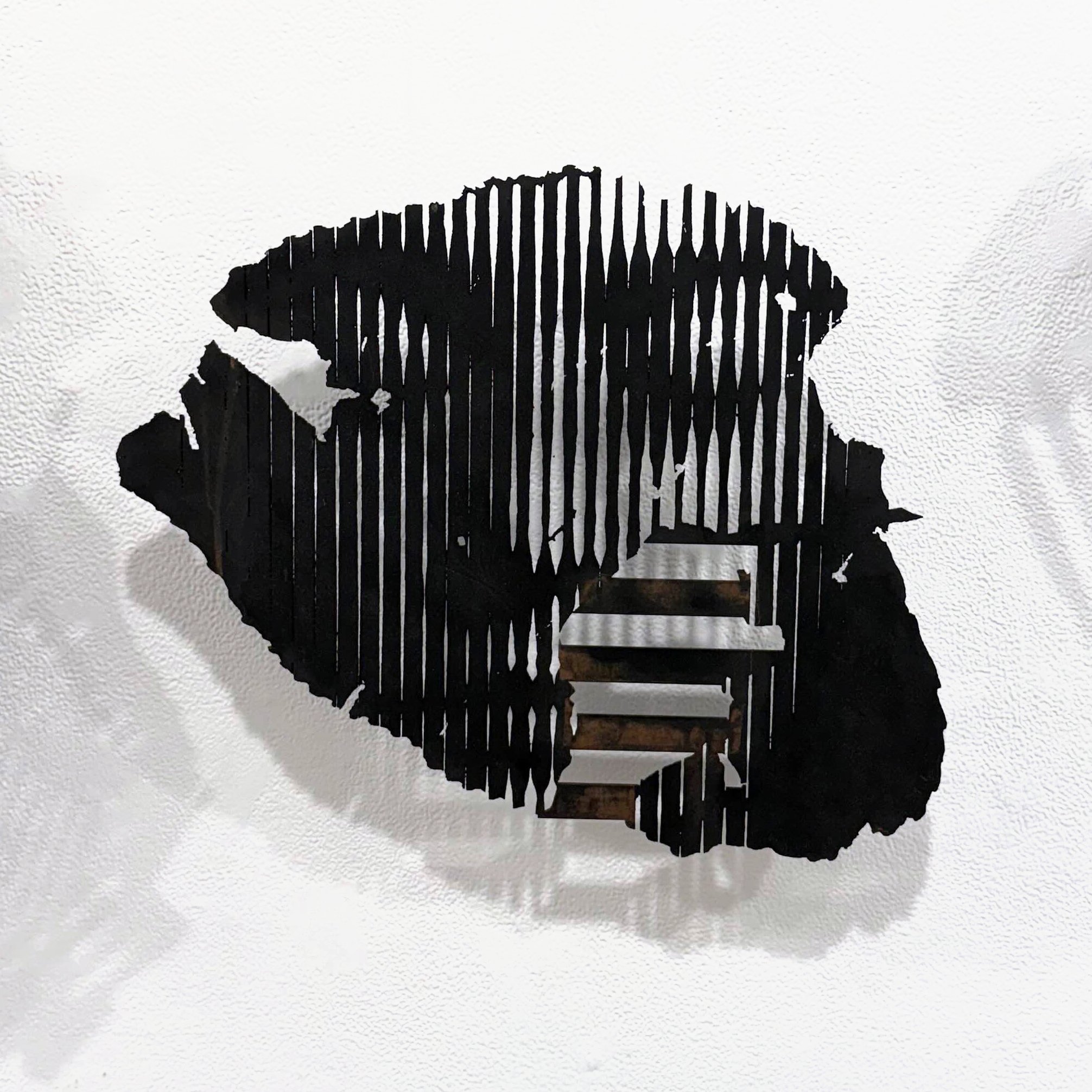  Jon Roberts, “Scrap Series: Shipwreck,” 2025. Iron and copper coatings on wood, patina, 15 × 18 inches. 