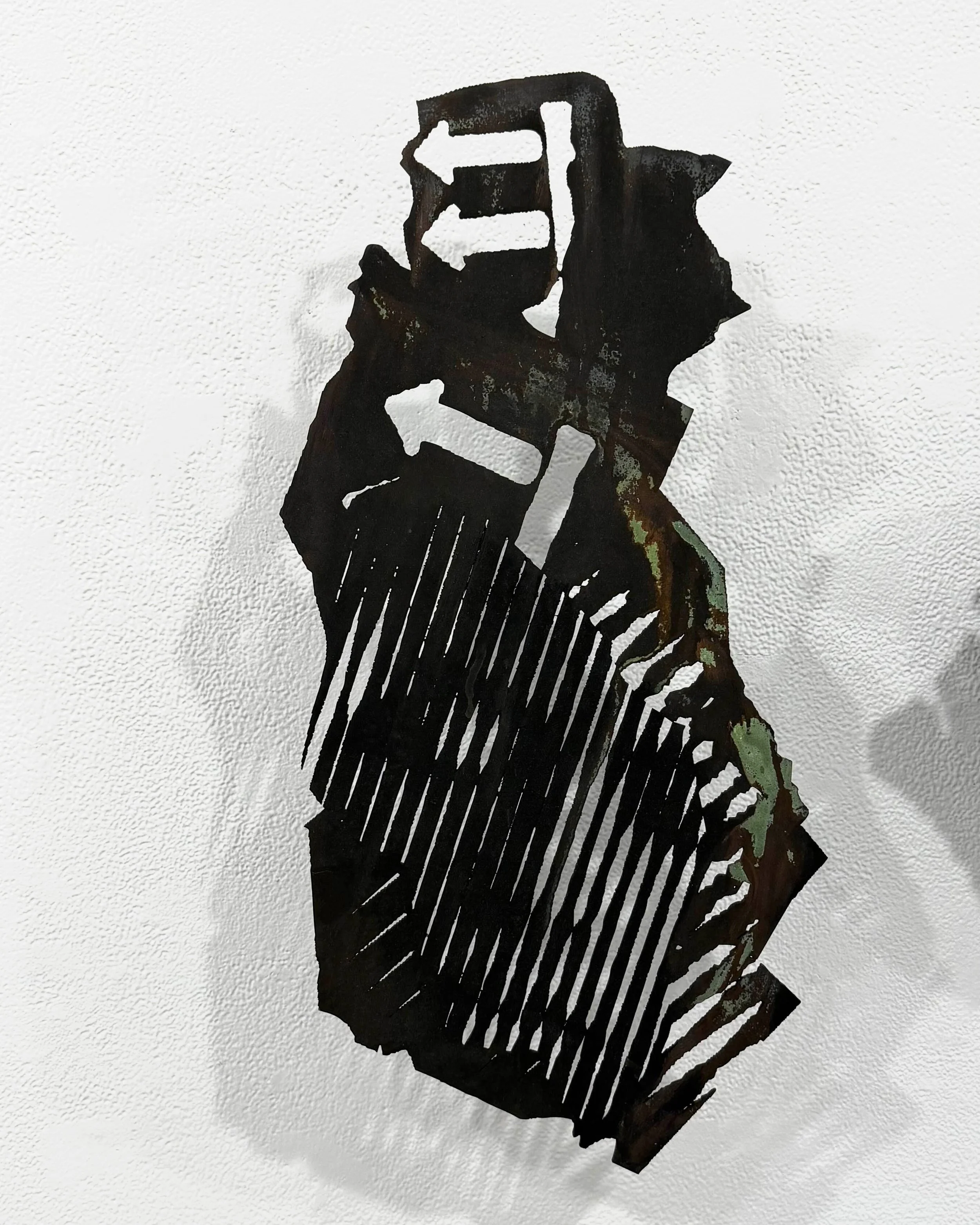  Jon Roberts, “Scrap Series: There,” 2025. Iron and copper coatings on wood, patina, 22 × 11 inches. 