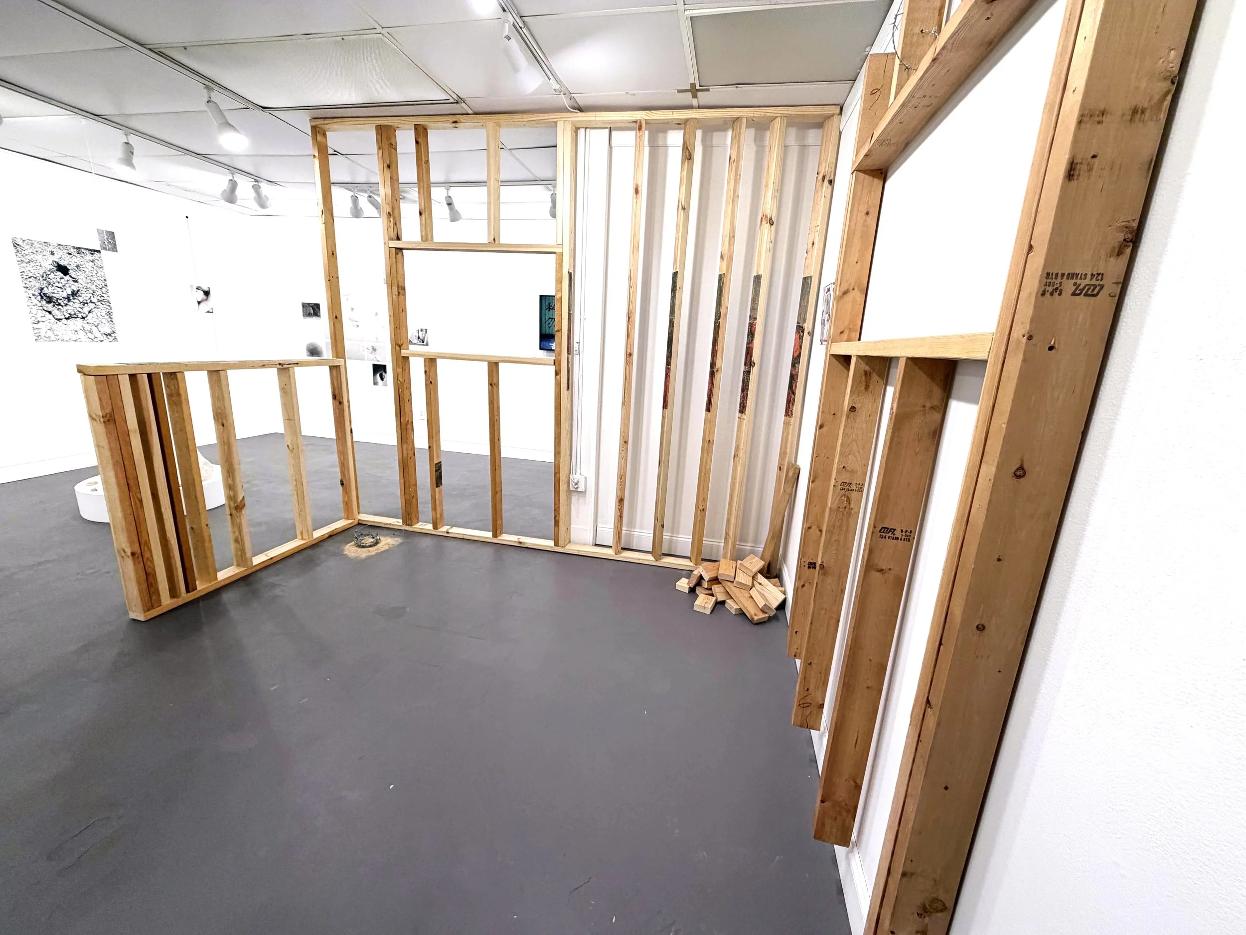  Noah Reyes, “Untitled site specific installation,” 2026. Plywood, photo transfers, and barbed wire, dimensions variable.  