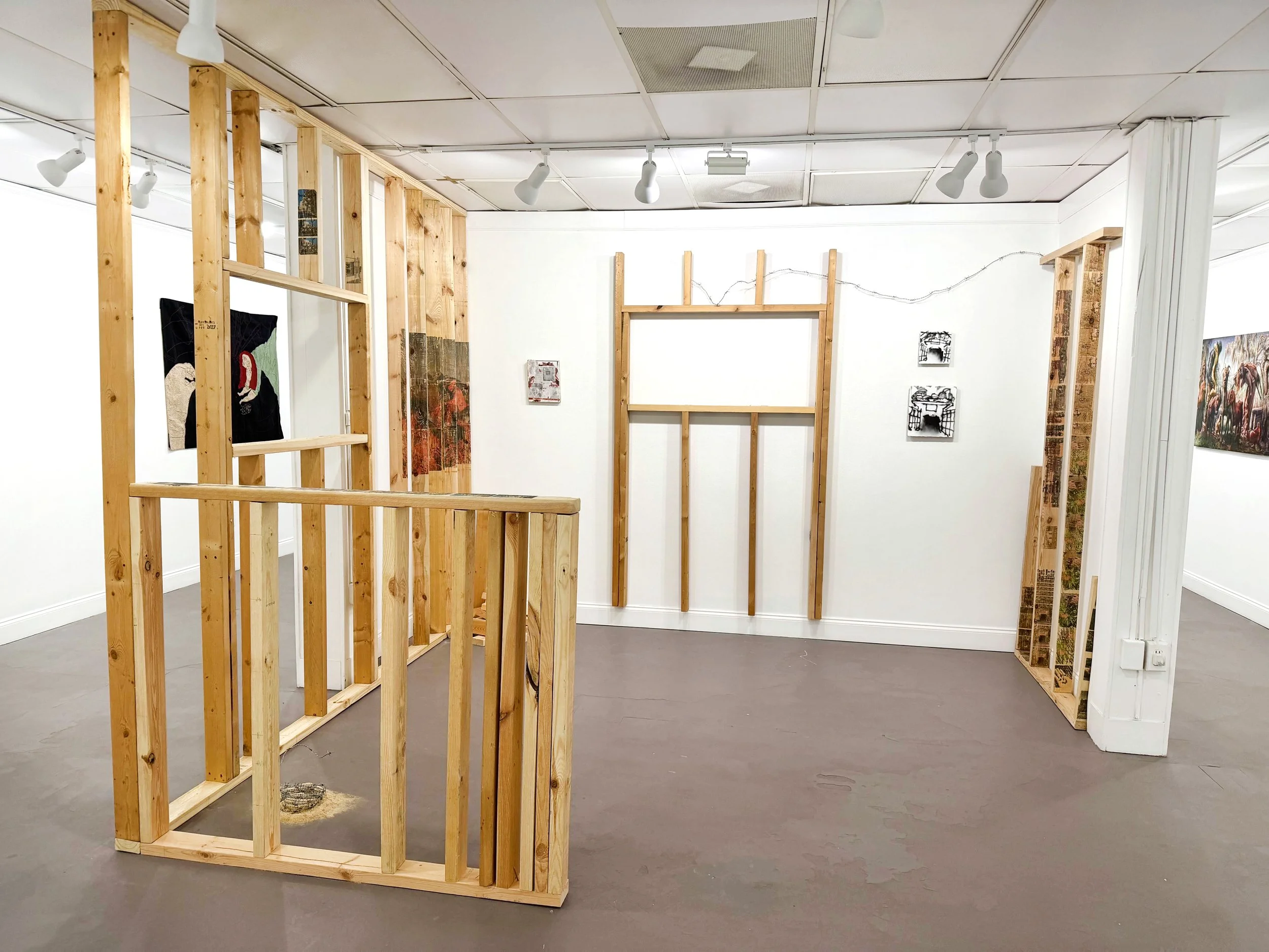  Noah Reyes, “Untitled site specific installation,” 2026. Plywood, photo transfers, and barbed wire, dimensions variable.  