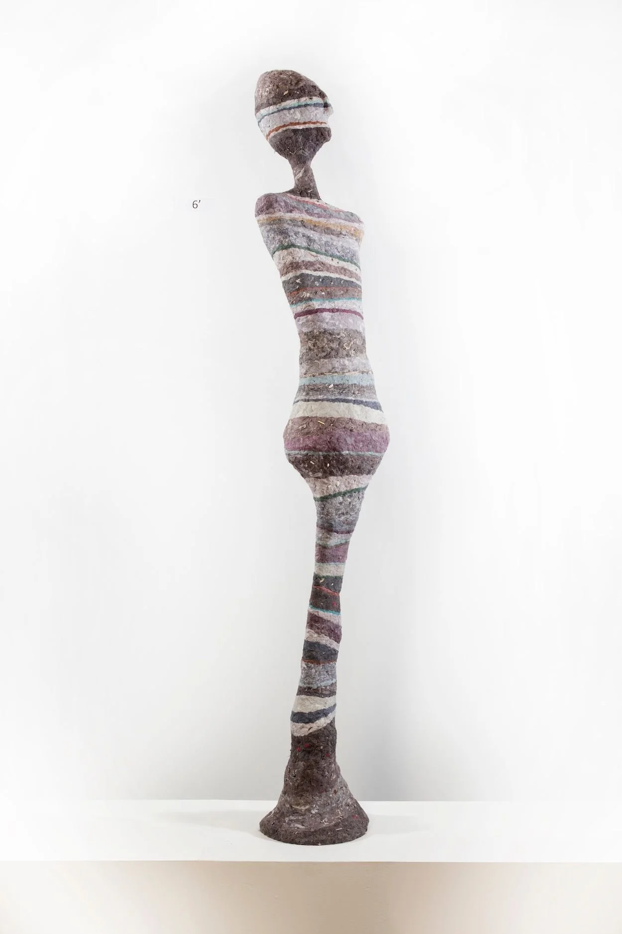  Cheryl Capezzuti,  Monopedal Masked&nbsp; V (Gradient),  2020. 90 x 15 x 15 inches, Residential dryer lint collected at the deck hockey rink.  