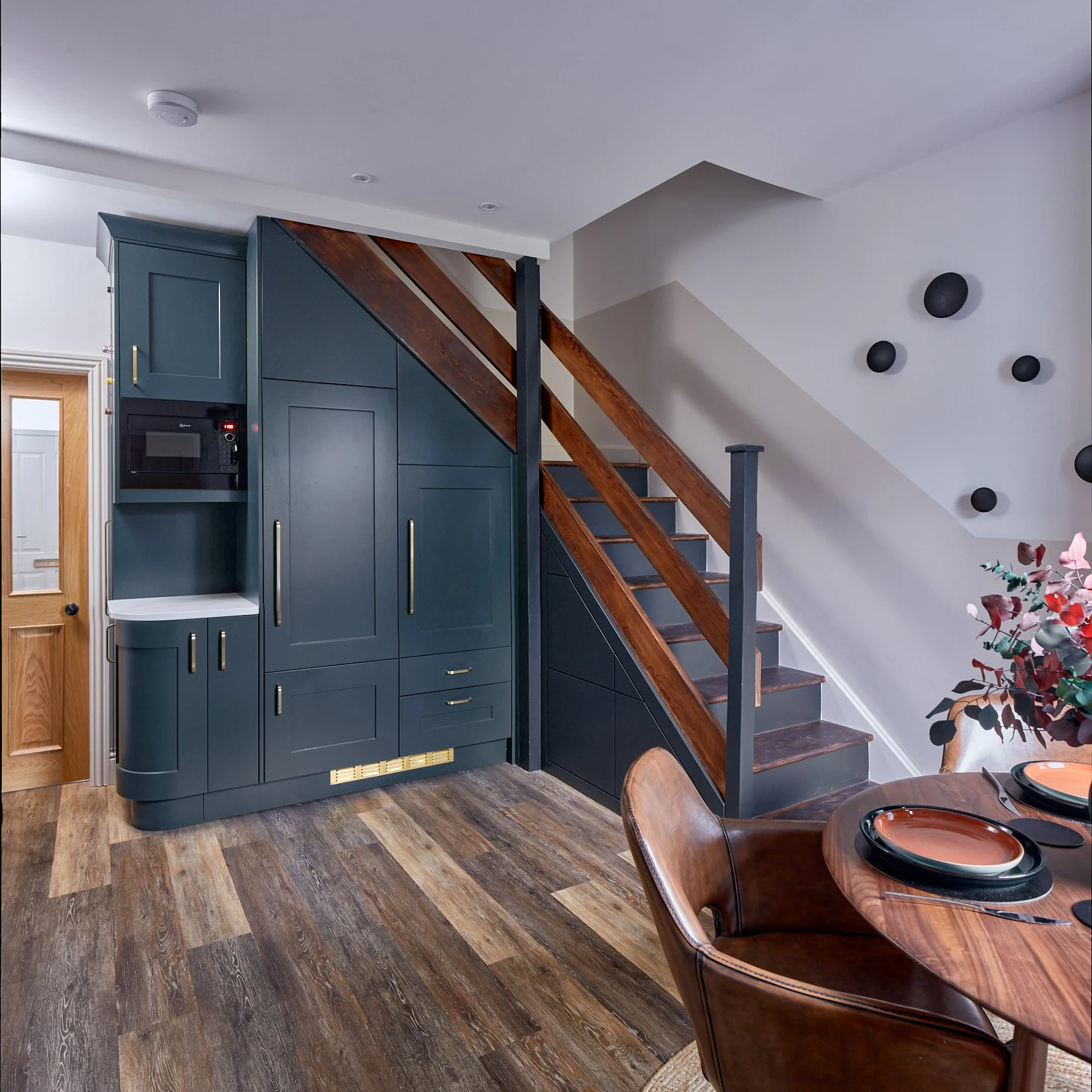 Refrigeration, microwave and integrated bin fitted under the stairs