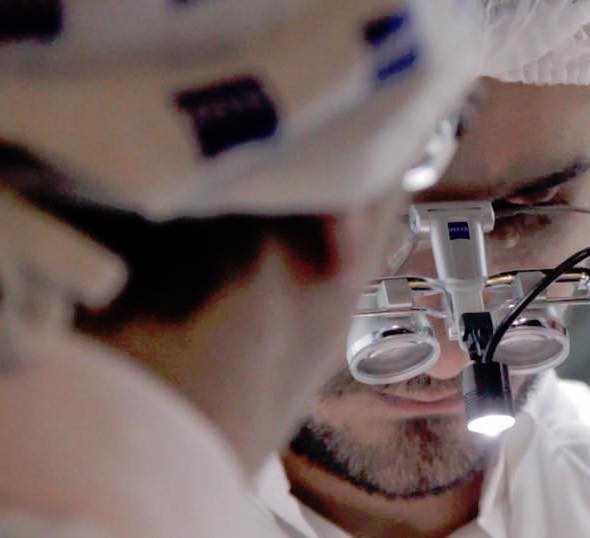 Surgeon wearing Carl Zeiss loupes and feather light led