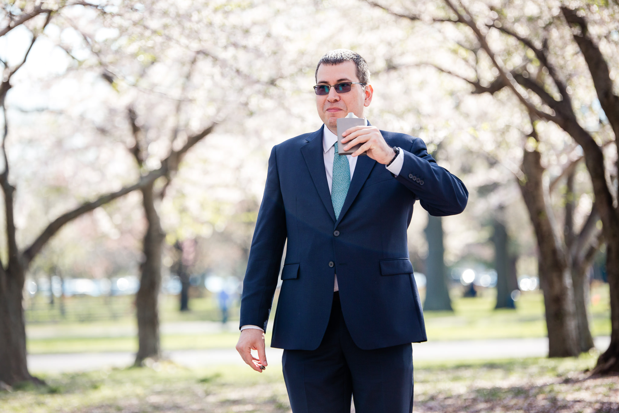 groom drinks from his pocket flask