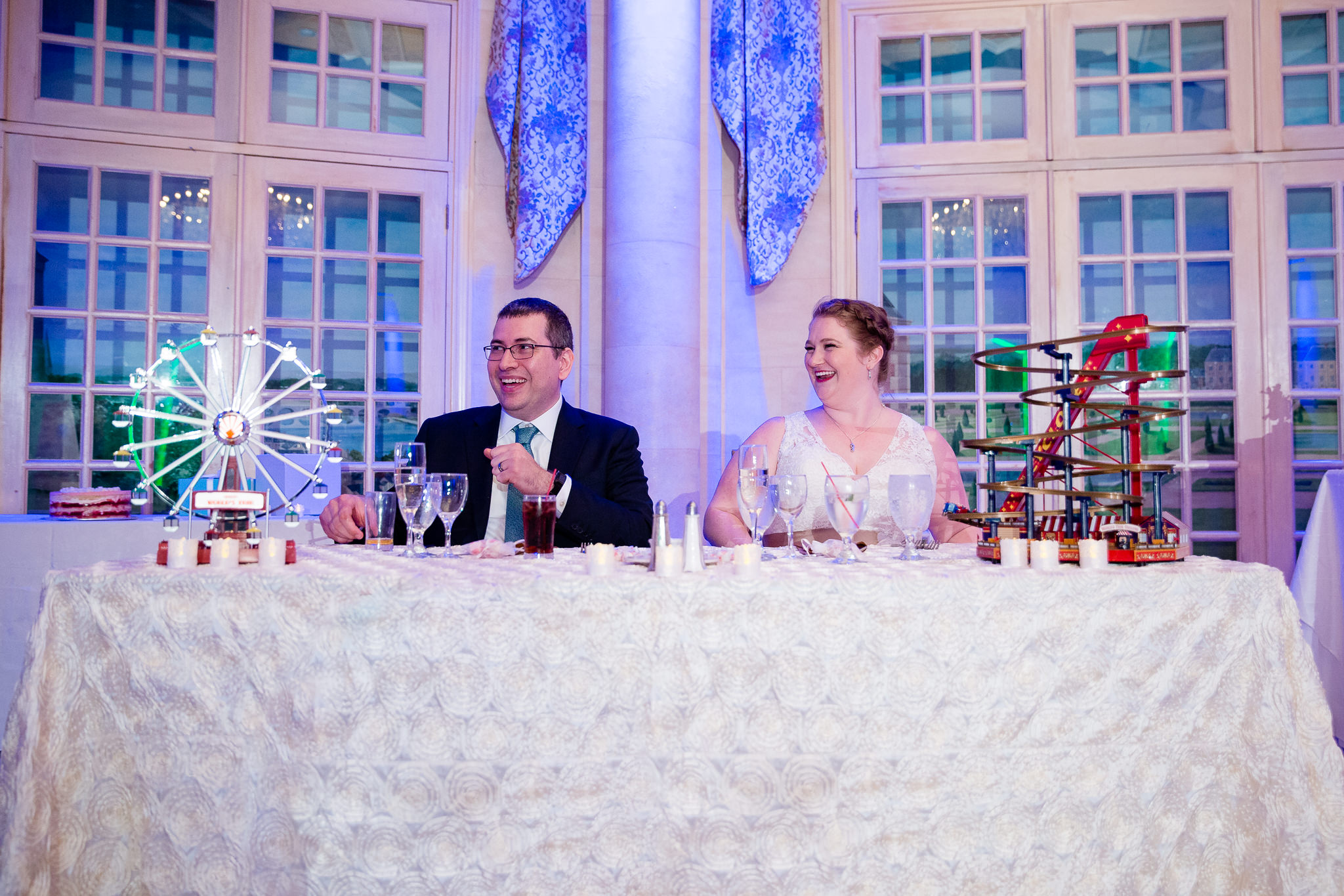 couple laughs at wedding party speeches