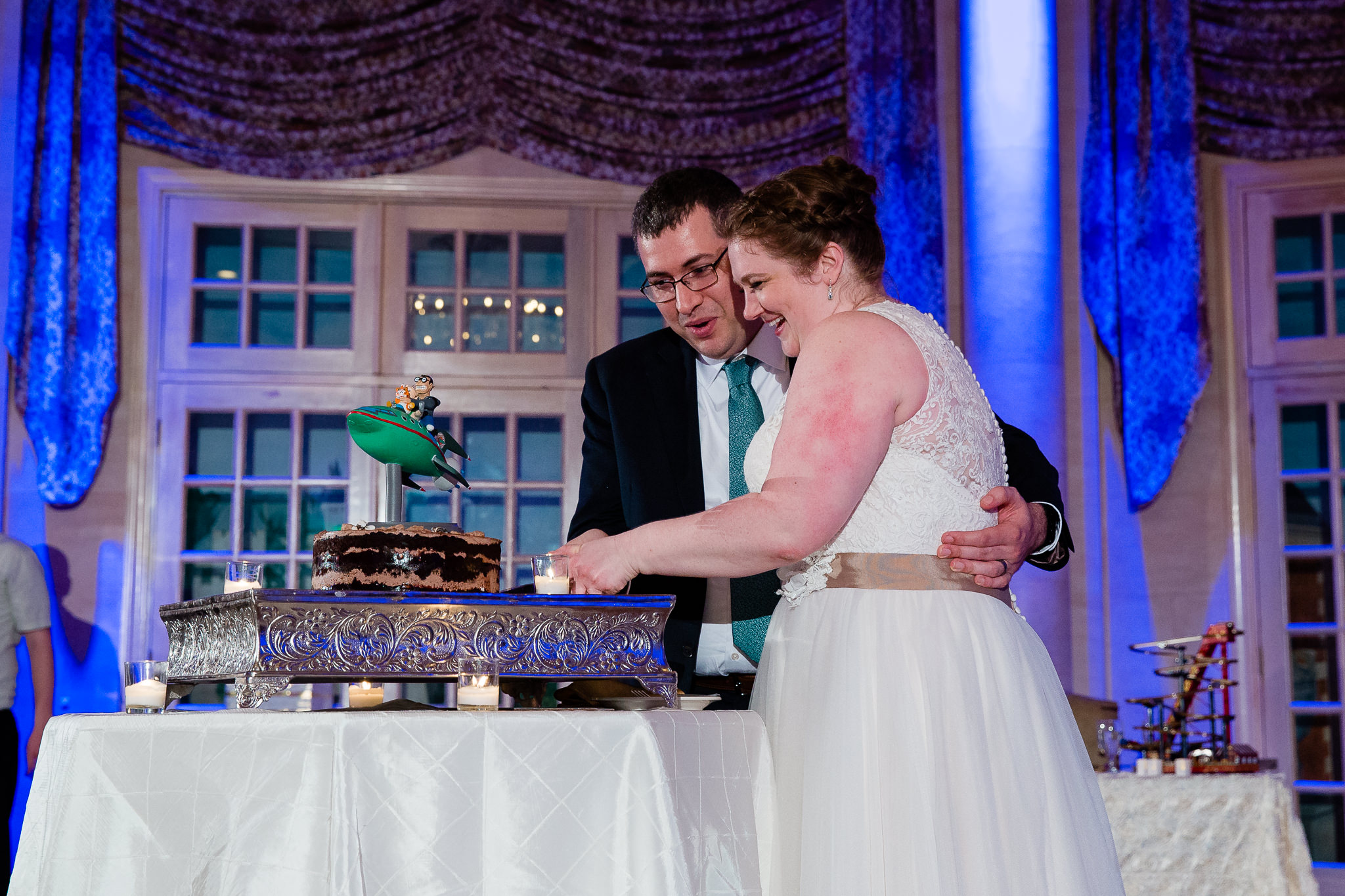 couple cuts momofuku milk bar wedding cake with futurama wedding cake topper