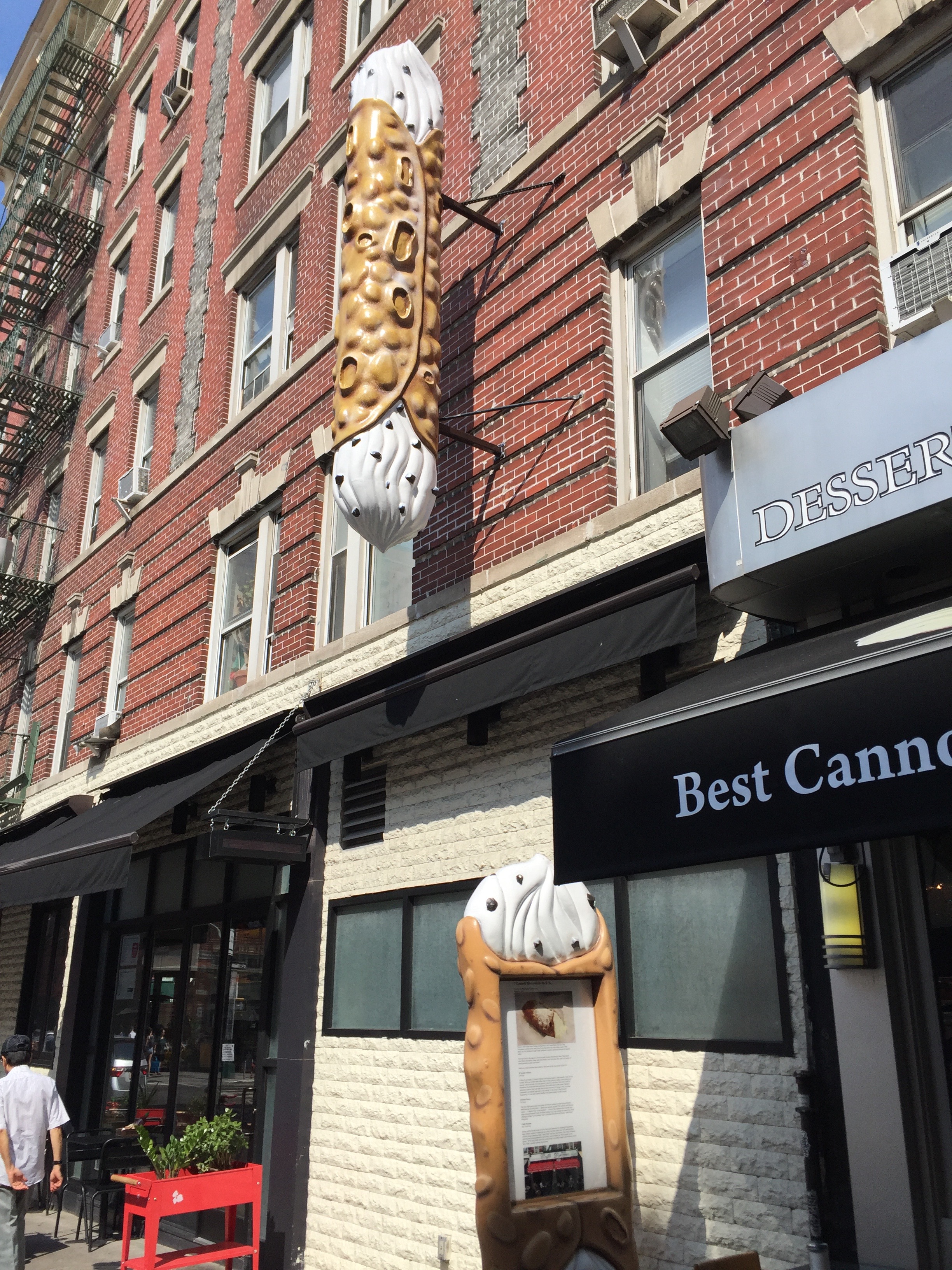 Cannoli sign suspended from building