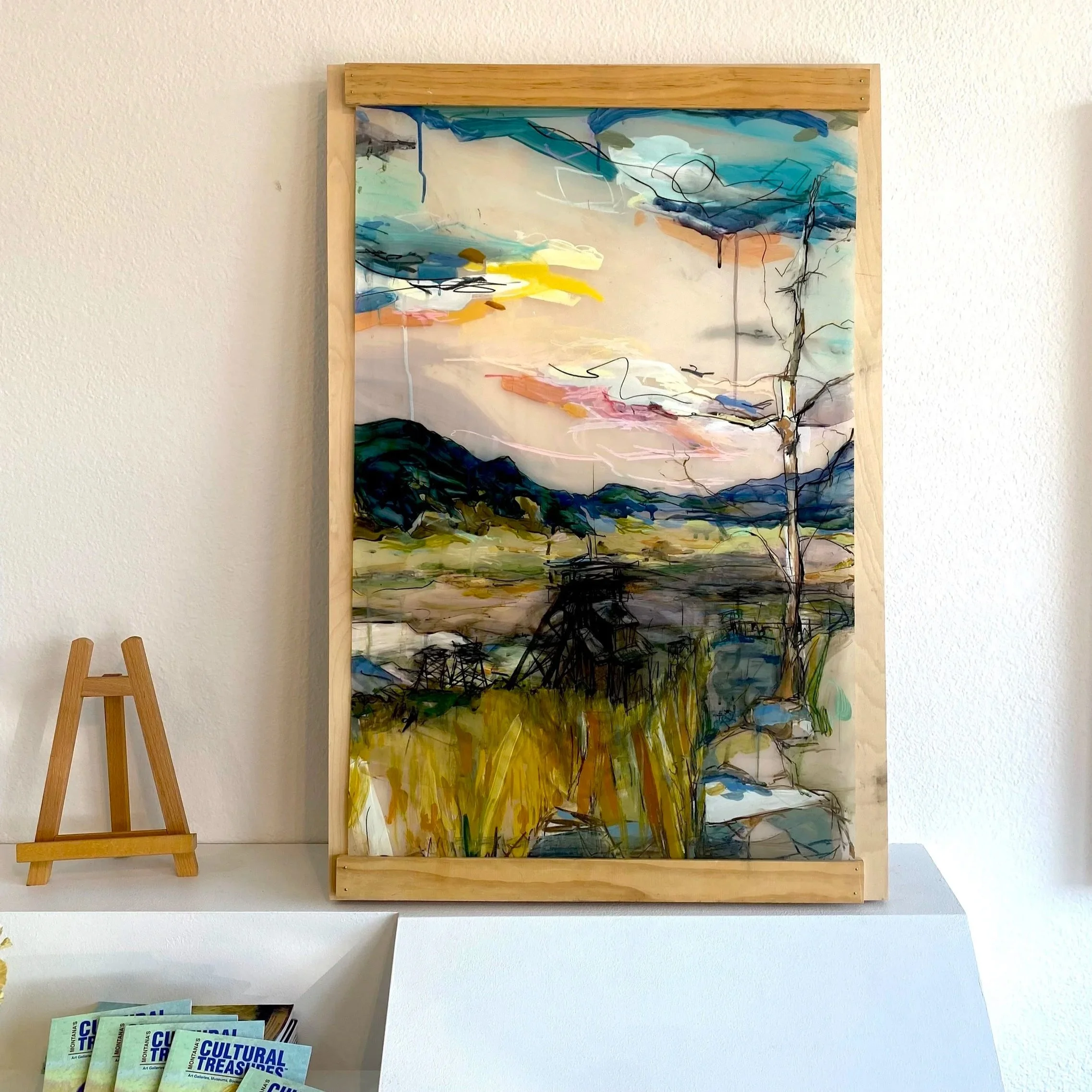 Abstracted Landscape Painting by Leah Cupino with a view of the Headframe on the hill and valley with mountains and drippy paint sky in the distance from Walkerville in Butte Montana,  copyright 2021