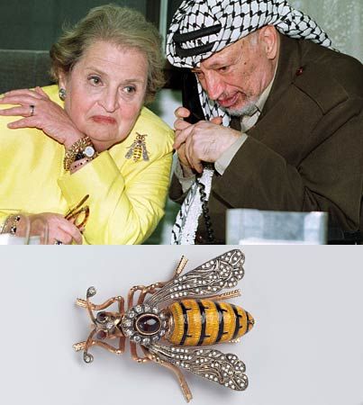 Yasser Arafat and Albright speaking by phone with President Clinton. Albright spent many hours wrangling with the Palestinian leader about the need for compromise in the Middle East. Her pin reflected her mood.