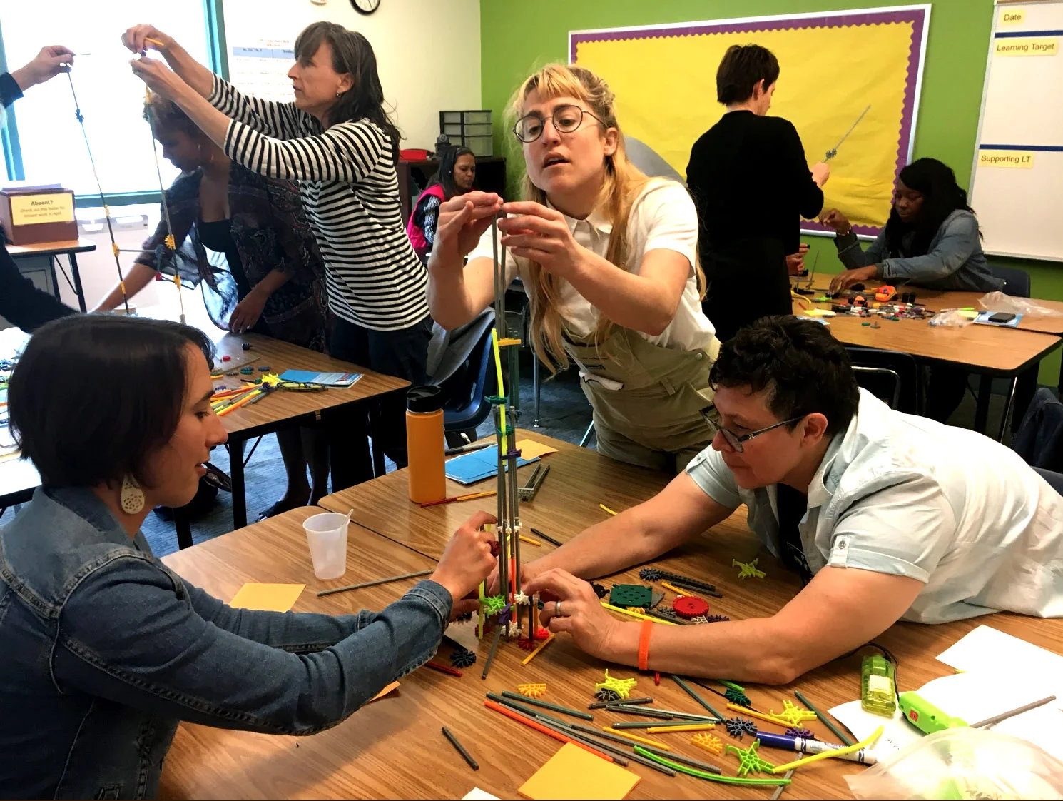 Participants collaboratively building during a design challenge in "Building Collegiality around Maker-Centered Learning - BRING THE FUN BACK TO LEARNING," with Teacher Fellows Clayton Evans , Physics and Engineering Teacher & Leah Jensen , Teacher Librarian, McClymonds HIgh School, OUSD