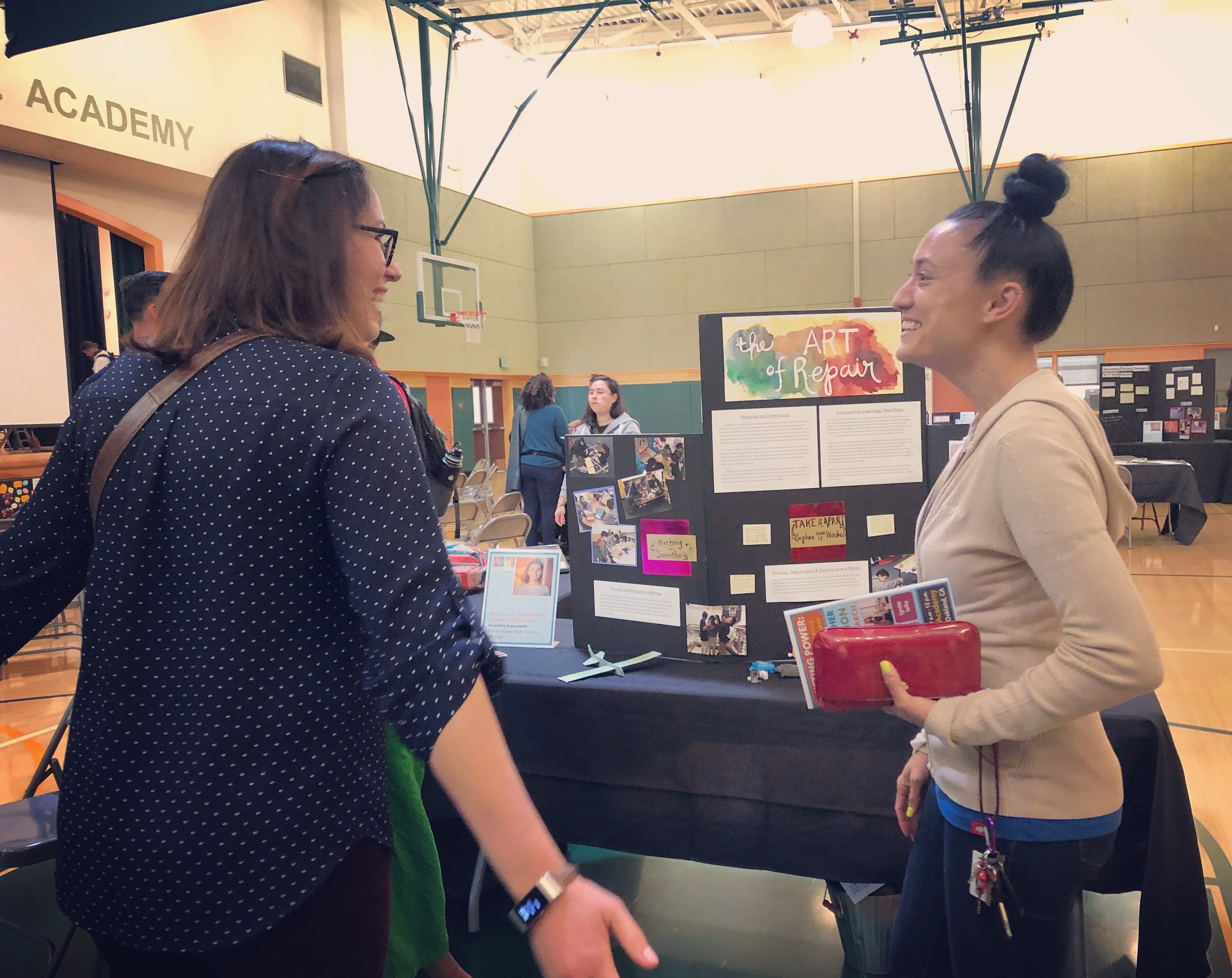Agency by Design Oakland fellow Julie Ellis and a participant catching up near Shraddha Soparawala’s documentation booth entitled “Art of Repair: Transforming Objects and Ourselves.”