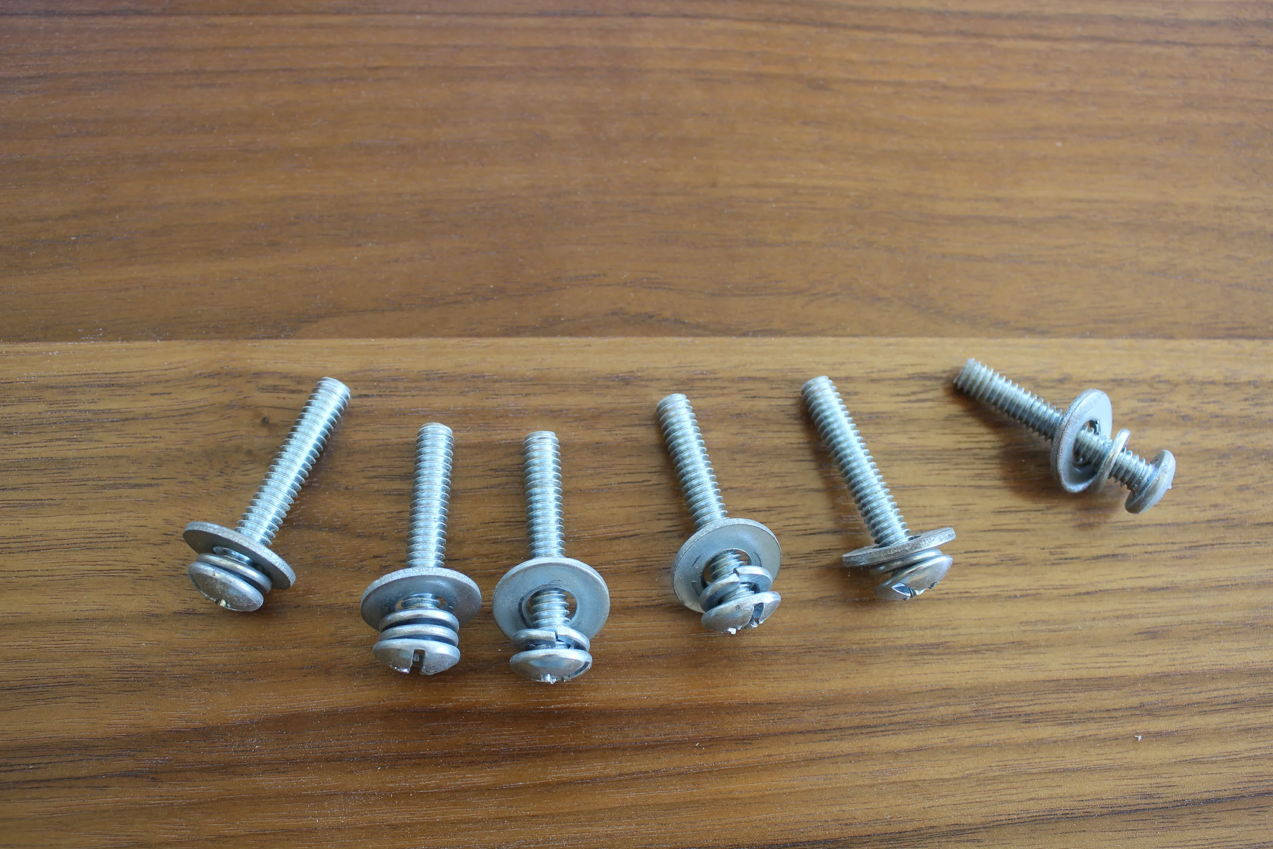 Note the order of things: little washer closet to screw head, big washer closest to table.